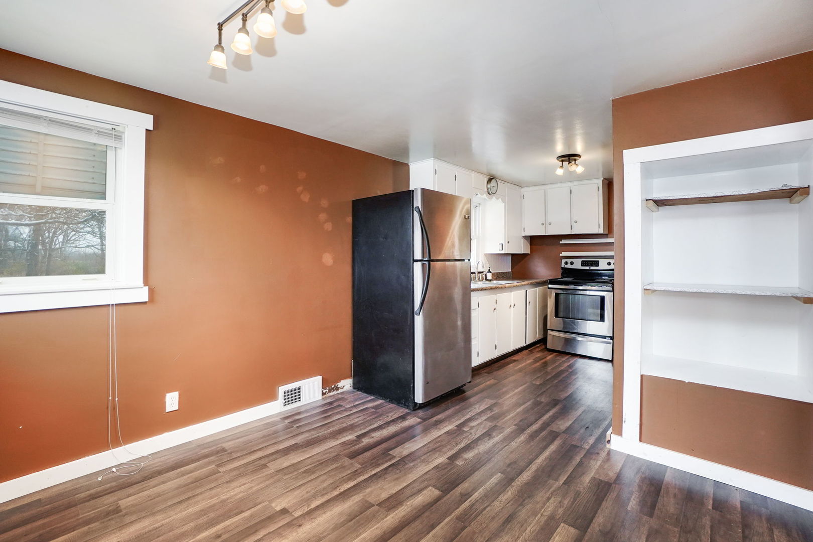 1737 Lee Center Road Amboy, IL 61310 - Photo 6 of 19 a kitchen with stainless steel appliances a refrigerator and wooden floor
