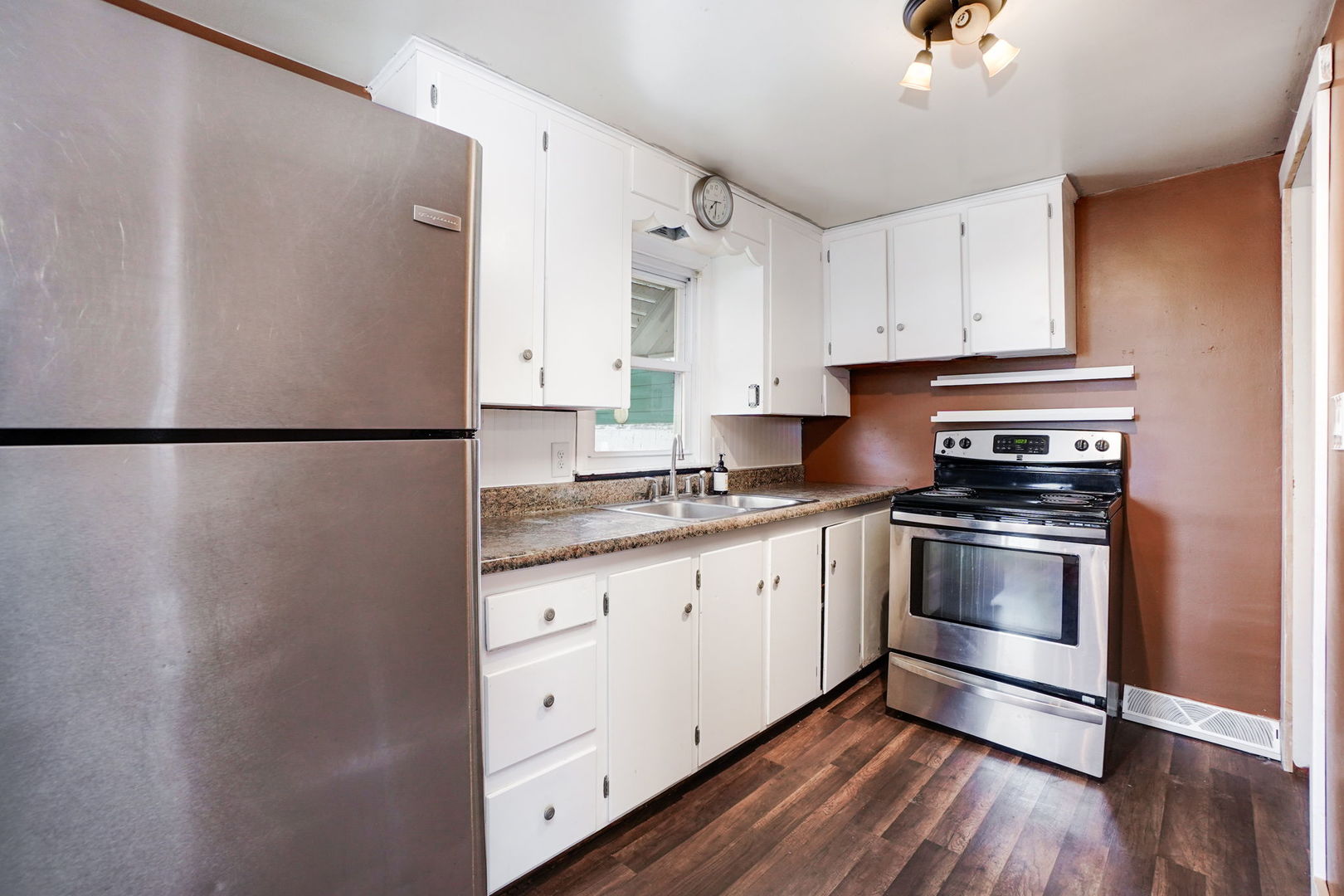 1737 Lee Center Road Amboy, IL 61310 - Photo 8 of 19 a kitchen with granite countertop a refrigerator sink and cabinets
