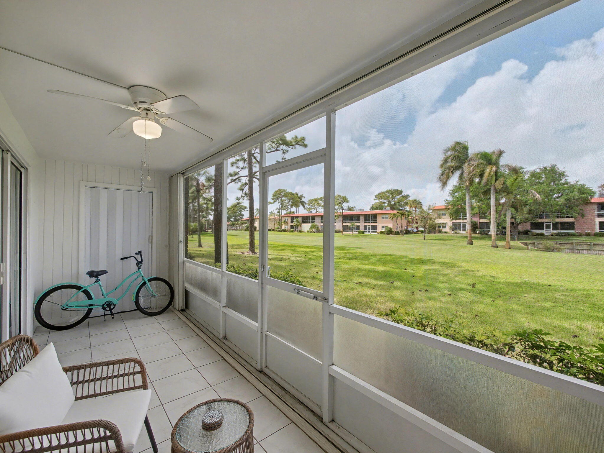 1967 Southwest Palm City Road, Unit 34C Stuart, FL 34994 - Photo 16 of 25 a view of a porch with furniture and a yard