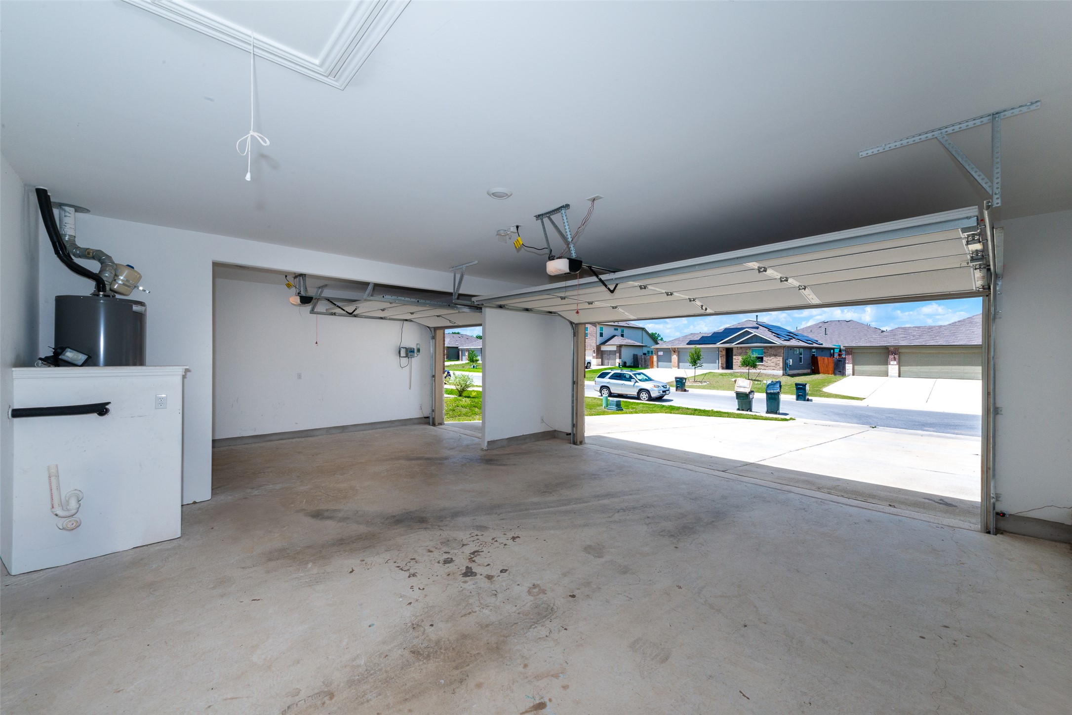 147 Otter Road Kyle, TX 78640 - Photo 32 of 34 Gigantic 3 car garage, excellent for those into projects, cars, woodworking etc. Insulated garage doors as well! Each has it's own garage door opener