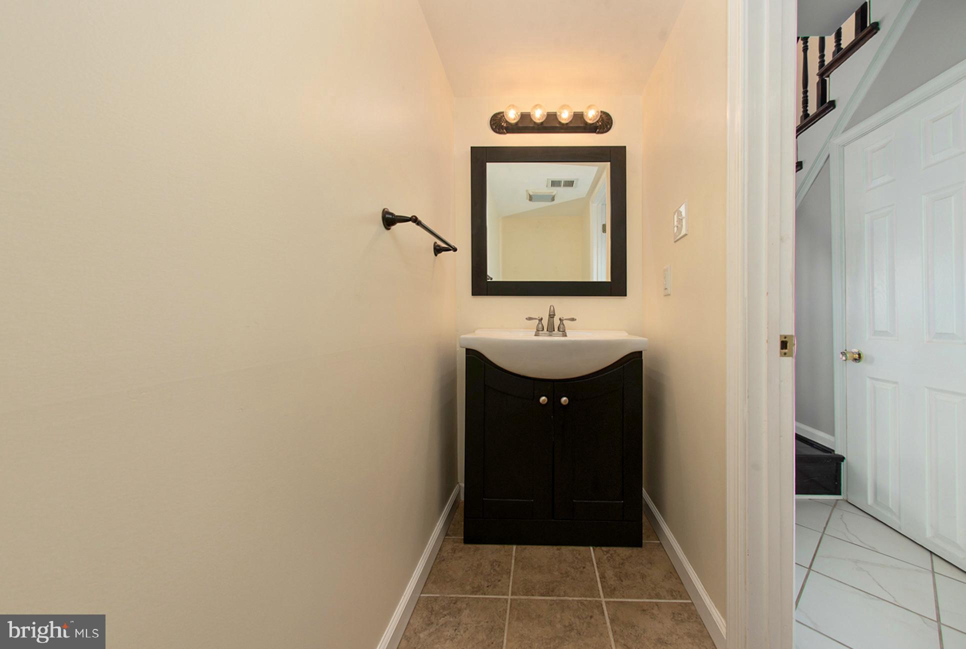 13349 Shea Place Herndon, VA 20170 - Photo 11 of 26 a bathroom with a sink and a mirror