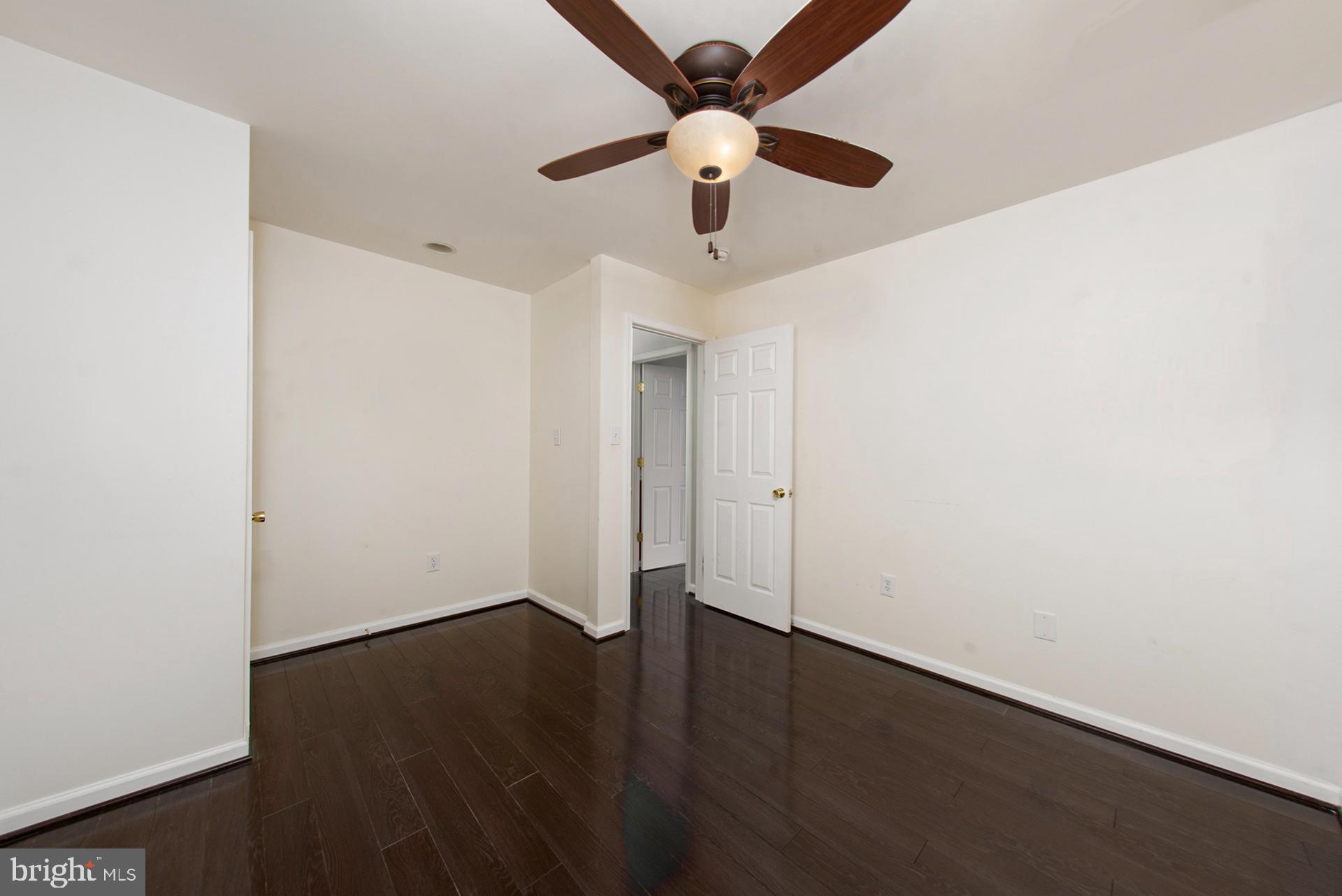 13349 Shea Place Herndon, VA 20170 - Photo 16 of 26 an empty room with wooden floor and a ceiling fan