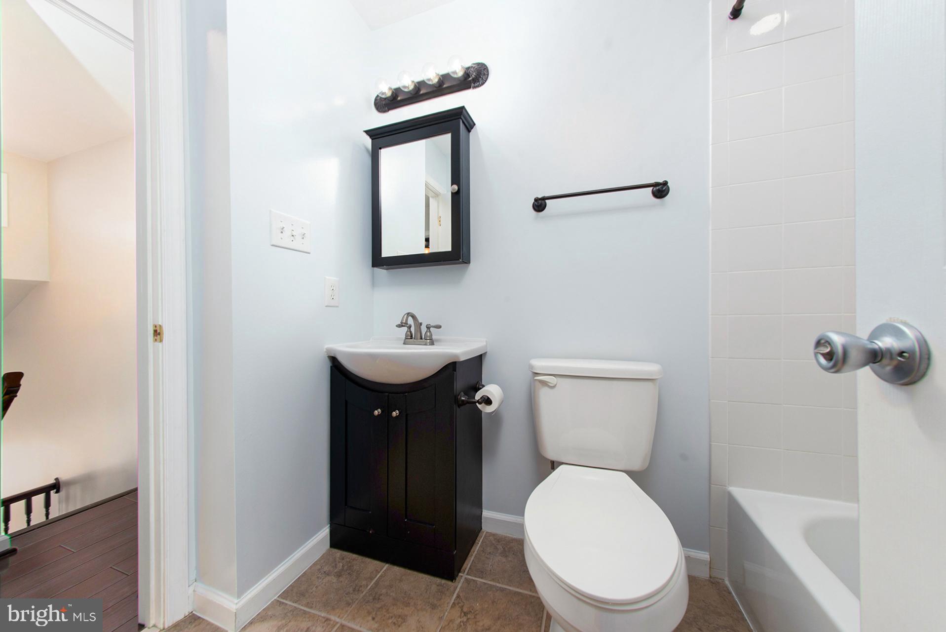 13349 Shea Place Herndon, VA 20170 - Photo 20 of 26 a bathroom with a toilet a sink and mirror