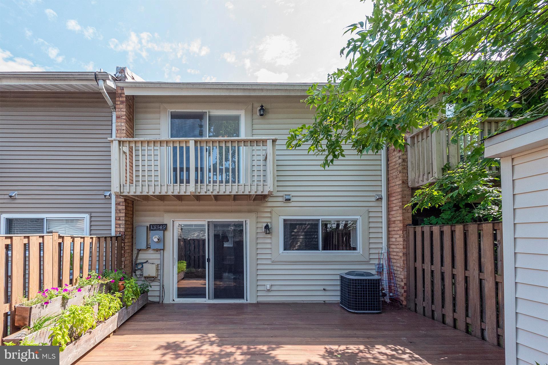 13349 Shea Place Herndon, VA 20170 - Photo 21 of 26 a front view of a house with a garden