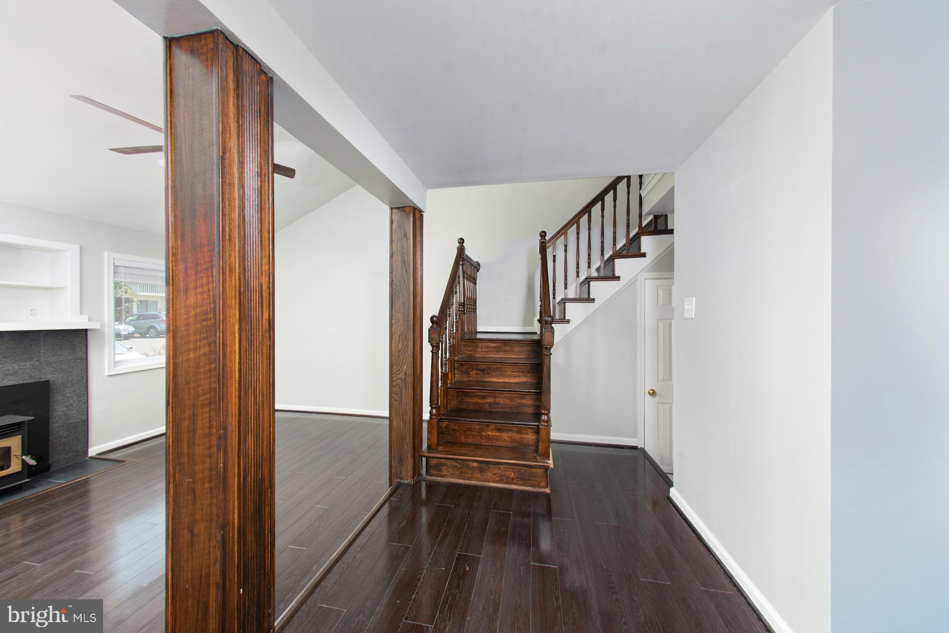 13349 Shea Place Herndon, VA 20170 - Photo 4 of 26 a view of hallway with stairs and wooden floor