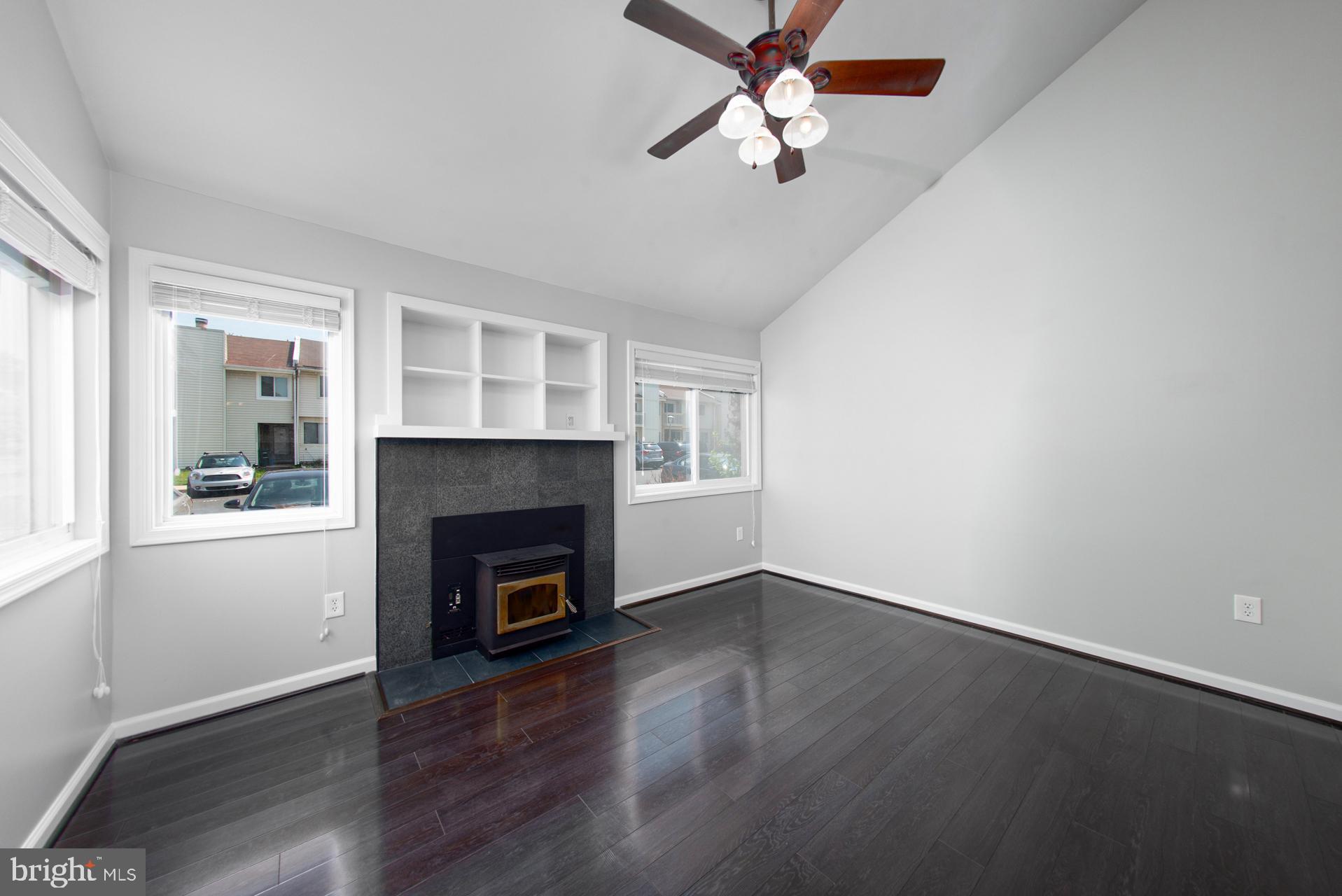 13349 Shea Place Herndon, VA 20170 - Photo 6 of 26 an empty room with windows a fireplace