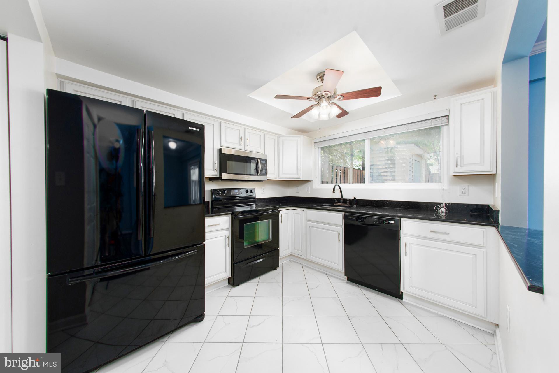 13349 Shea Place Herndon, VA 20170 - Photo 7 of 26 a kitchen with granite countertop a refrigerator stove top oven and sink