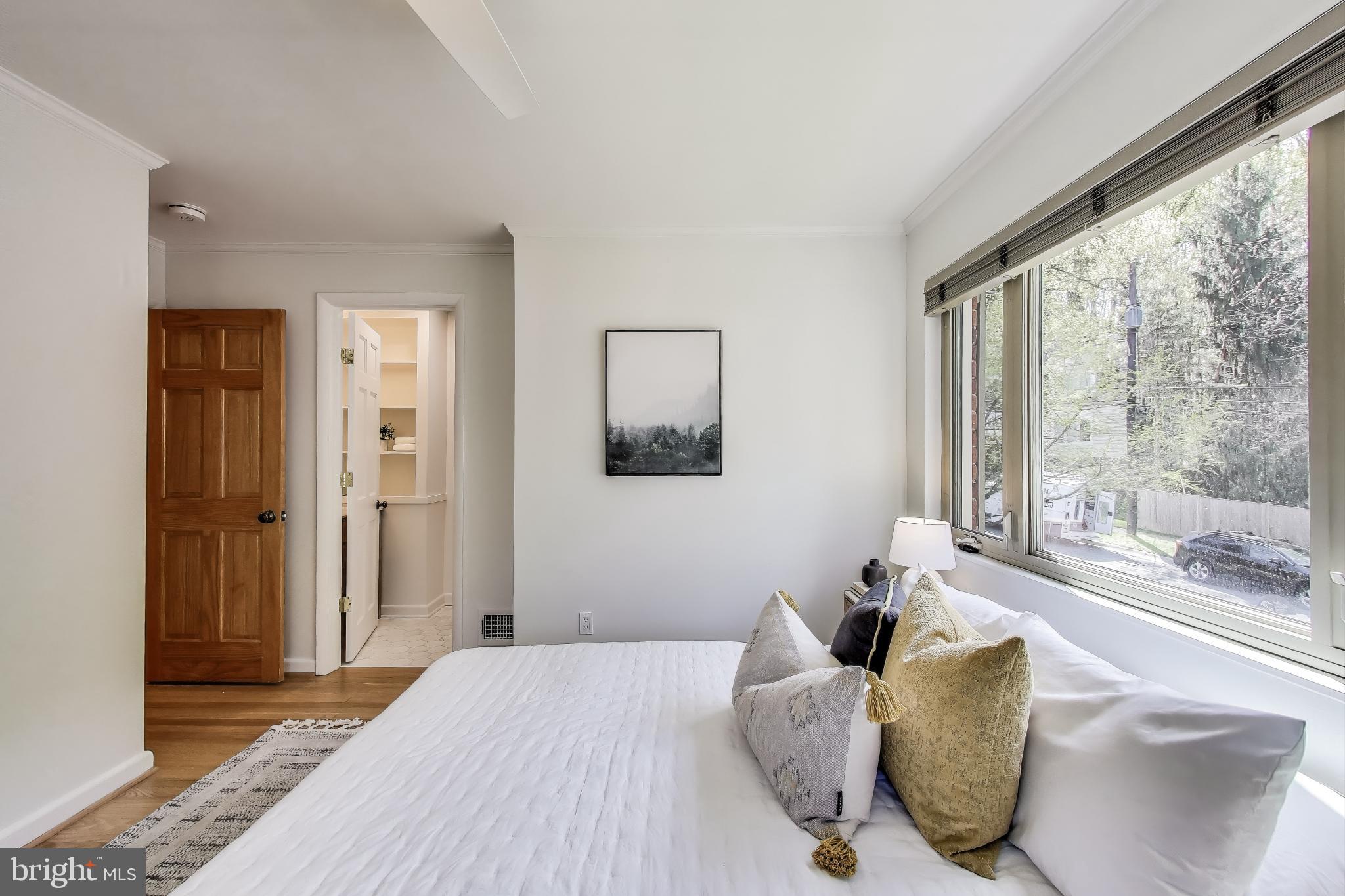 8905 Spring Valley Road Chevy Chase, MD 20815 - Photo 14 of 42 a bedroom with a large bed and a large window