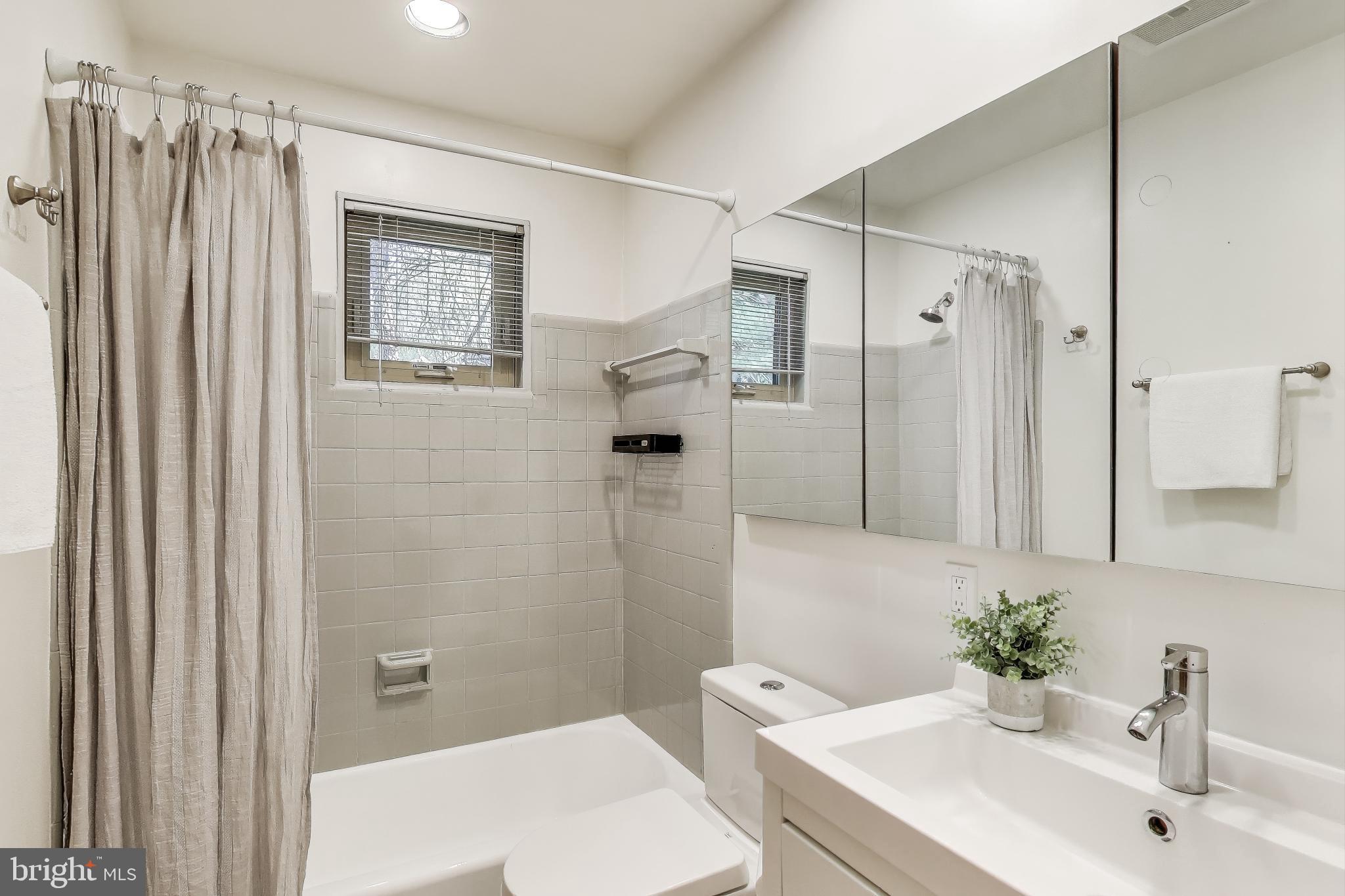 8905 Spring Valley Road Chevy Chase, MD 20815 - Photo 21 of 42 a bathroom with a sink toilet and shower