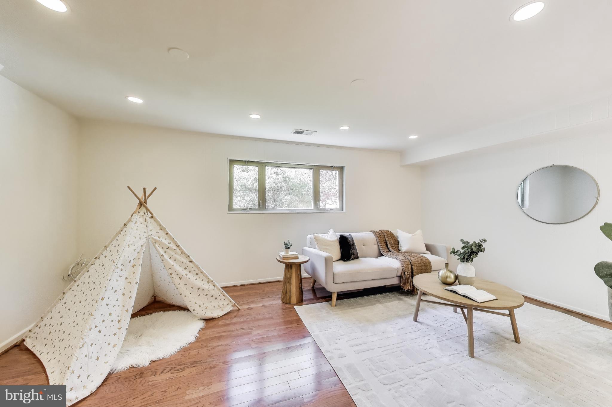 8905 Spring Valley Road Chevy Chase, MD 20815 - Photo 22 of 42 a living room with furniture and a window