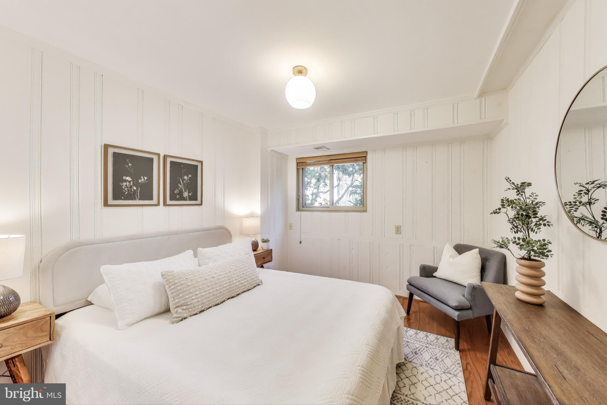 8905 Spring Valley Road Chevy Chase, MD 20815 - Photo 25 of 42 a bedroom with a bed and wooden floor
