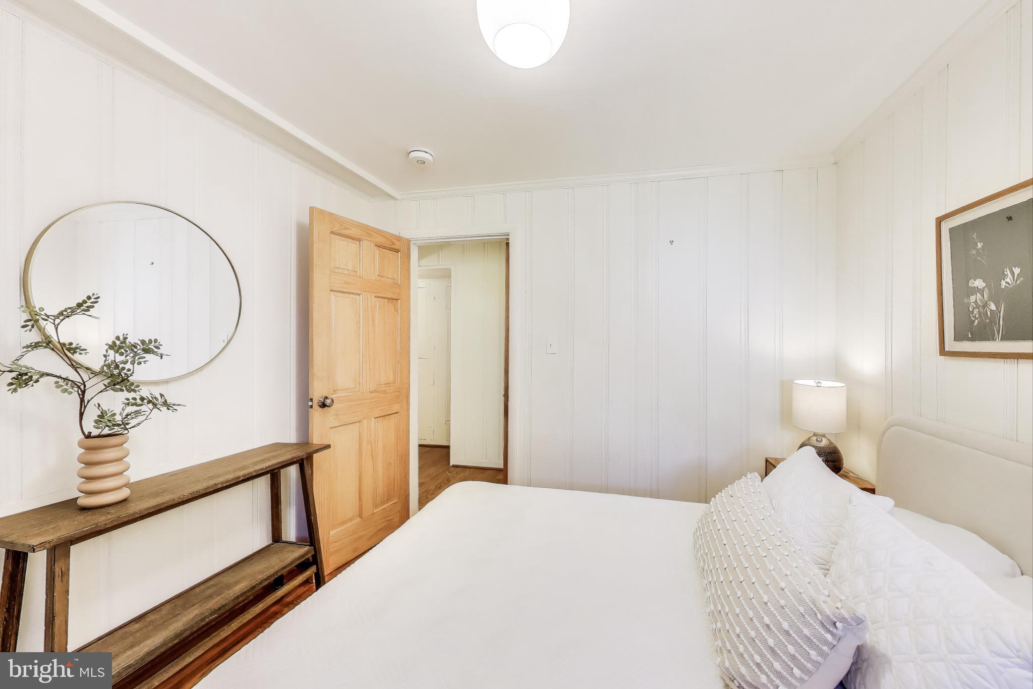 8905 Spring Valley Road Chevy Chase, MD 20815 - Photo 26 of 42 a bedroom with a bed lamp and a window