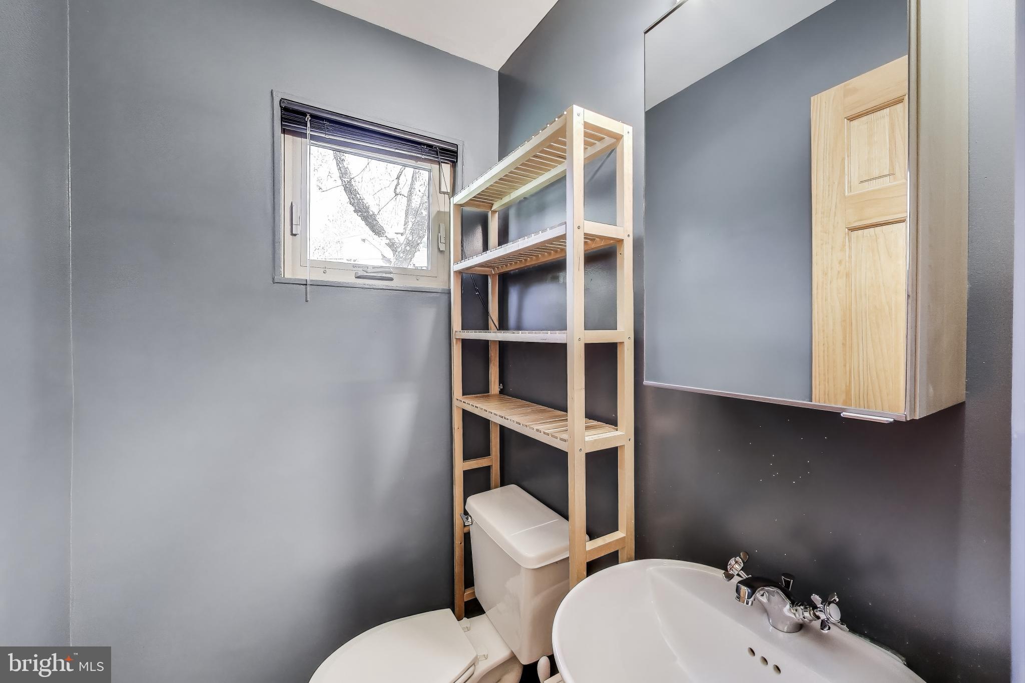 8905 Spring Valley Road Chevy Chase, MD 20815 - Photo 27 of 42 a white toilet sitting next to a bathroom sink