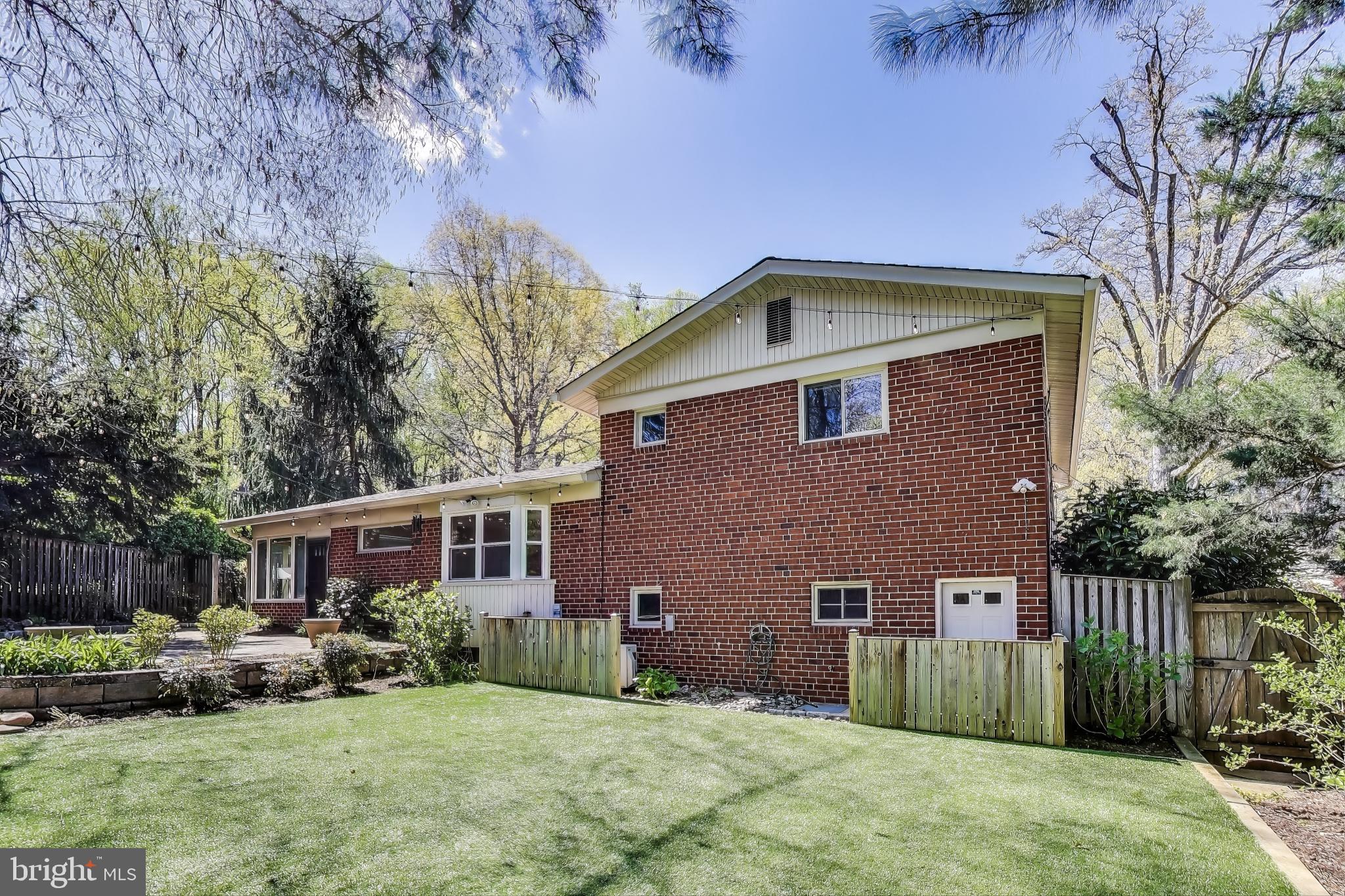 8905 Spring Valley Road Chevy Chase, MD 20815 - Photo 33 of 42 a front view of a house with a yard