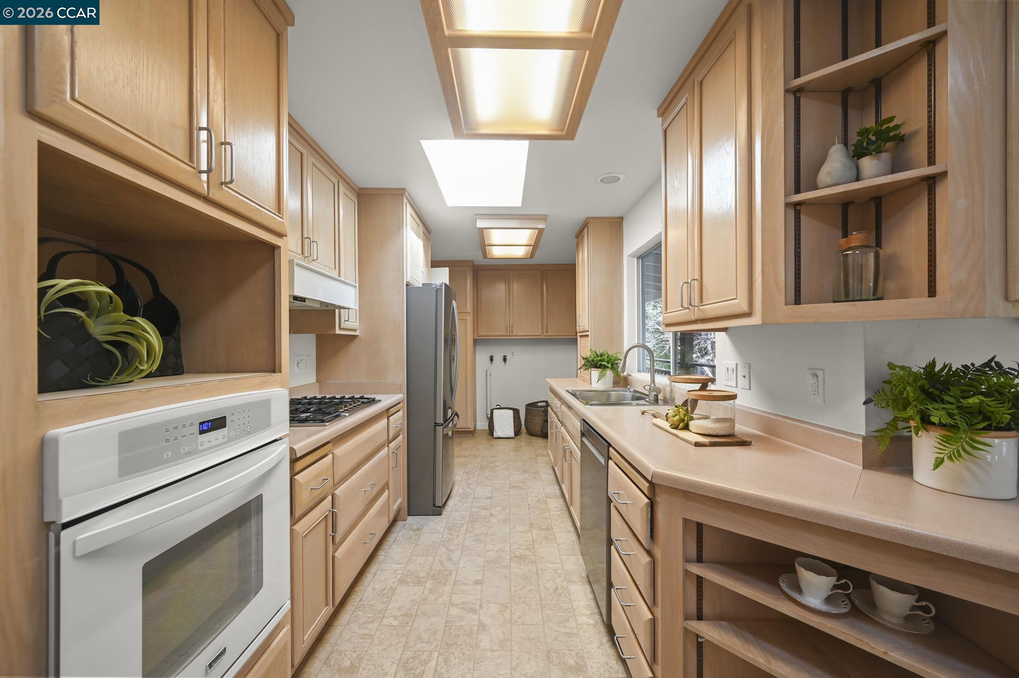 700 Miner Road Orinda, CA 94563 - Photo 13 of 37 a kitchen with a sink stove and cabinets
