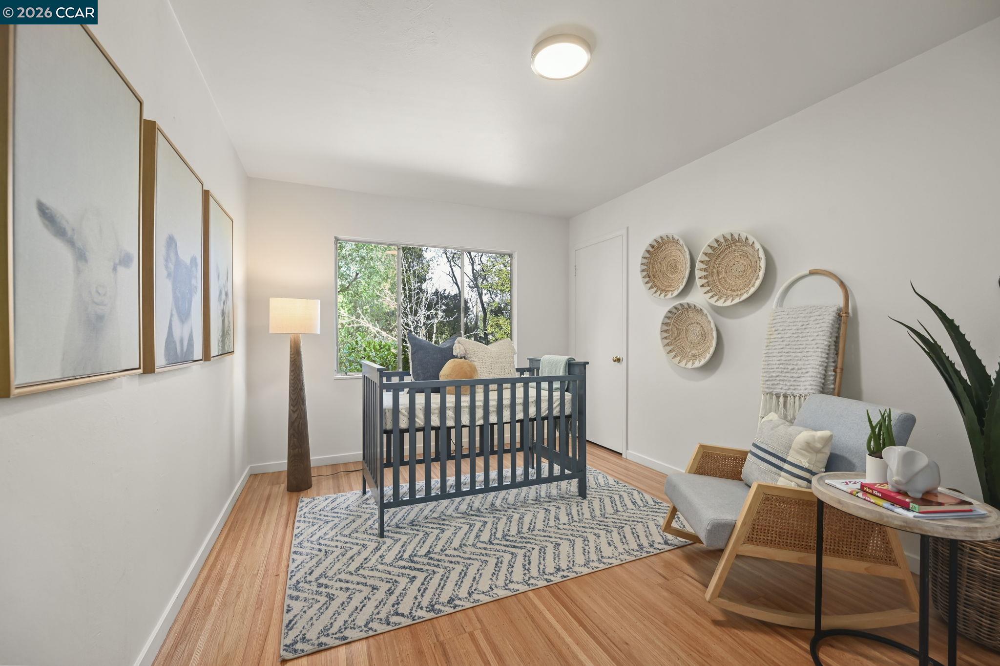 700 Miner Road Orinda, CA 94563 - Photo 16 of 37 a bedroom with furniture and a wooden floor