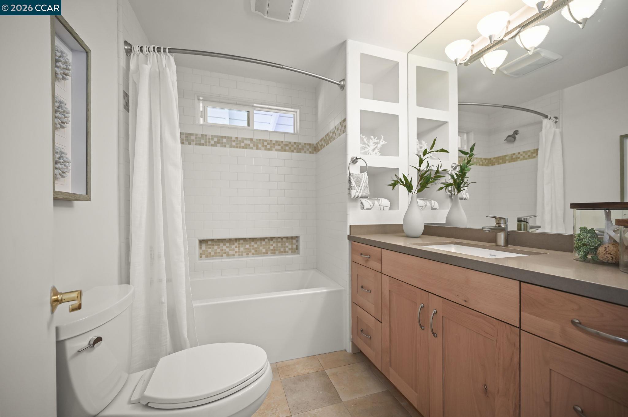 700 Miner Road Orinda, CA 94563 - Photo 17 of 37 a bathroom with a granite countertop sink toilet a large mirror a shower and a bathtub