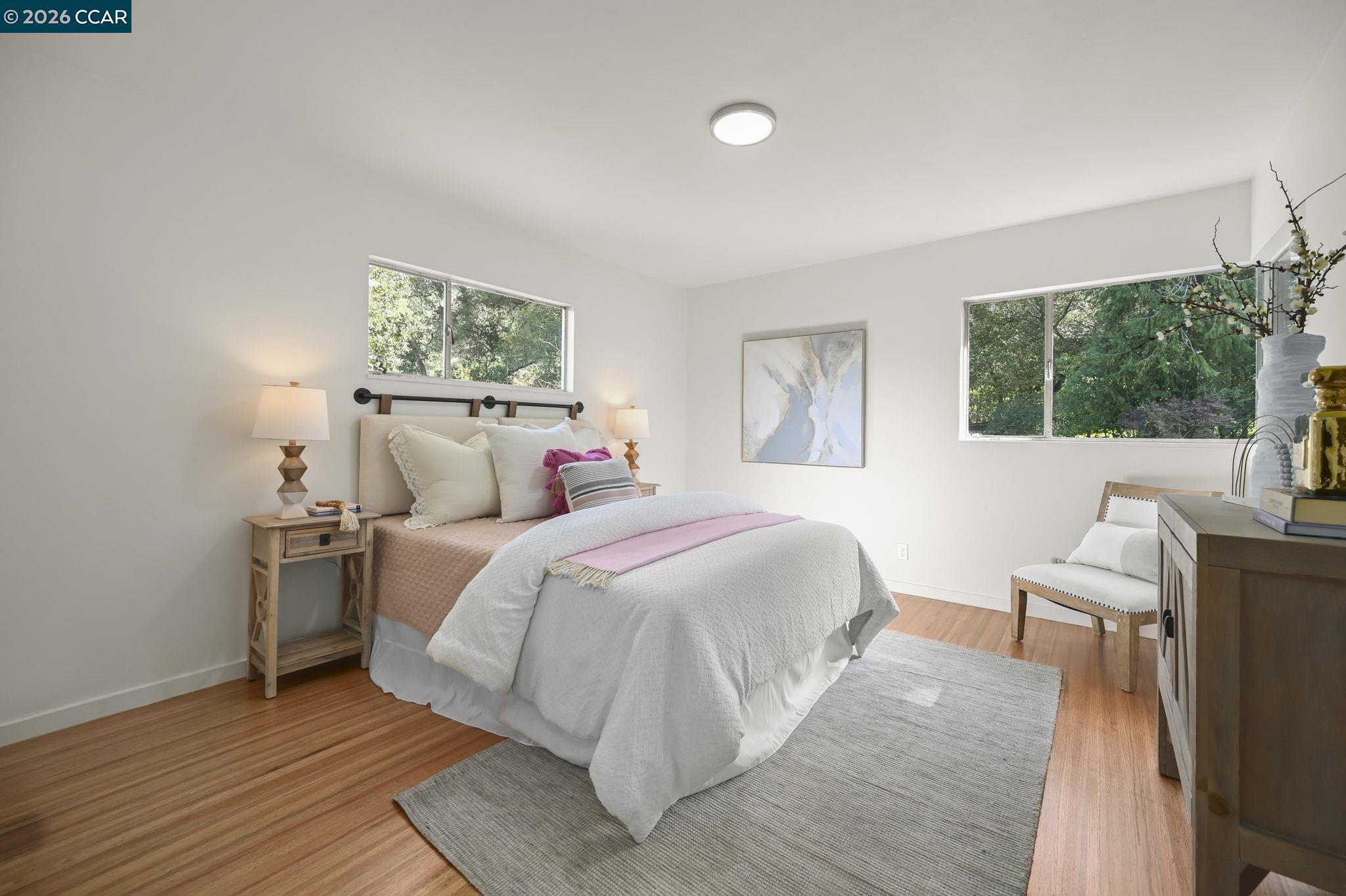 700 Miner Road Orinda, CA 94563 - Photo 18 of 37 a bed room with a bed and a chair