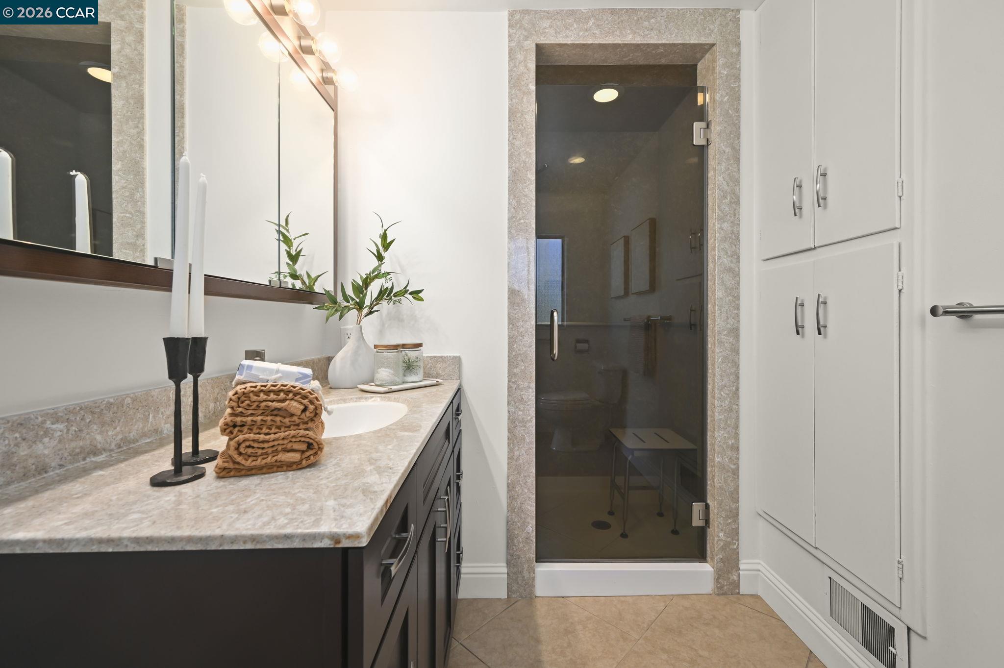 700 Miner Road Orinda, CA 94563 - Photo 22 of 37 a bathroom with a granite countertop sink and a mirror