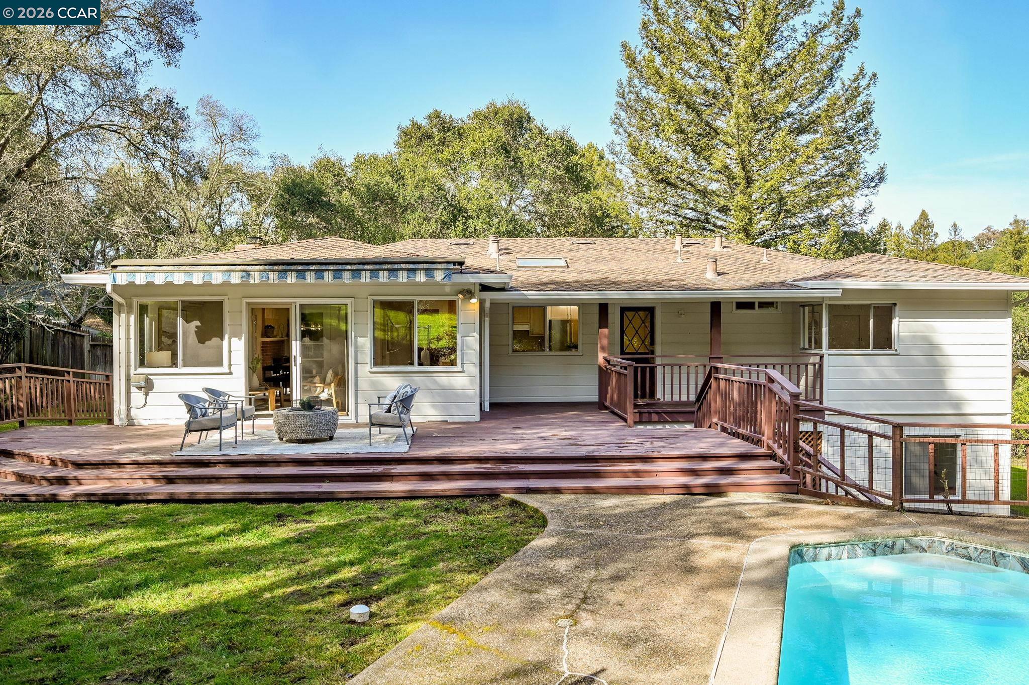 700 Miner Road Orinda, CA 94563 - Photo 27 of 37 a view of house with a big yard potted plants and large tree