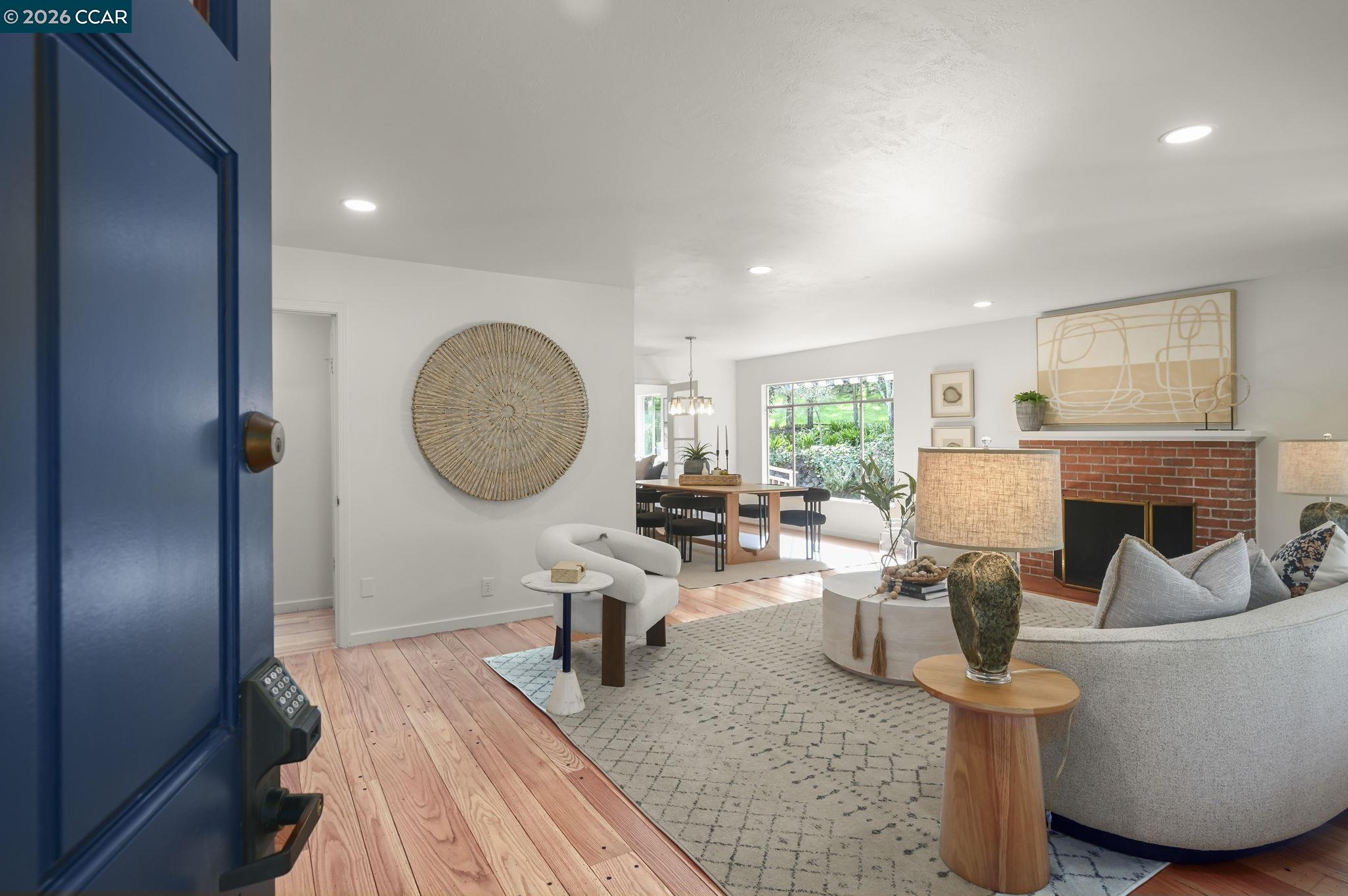 700 Miner Road Orinda, CA 94563 - Photo 4 of 37 a living room with fireplace furniture and a large window