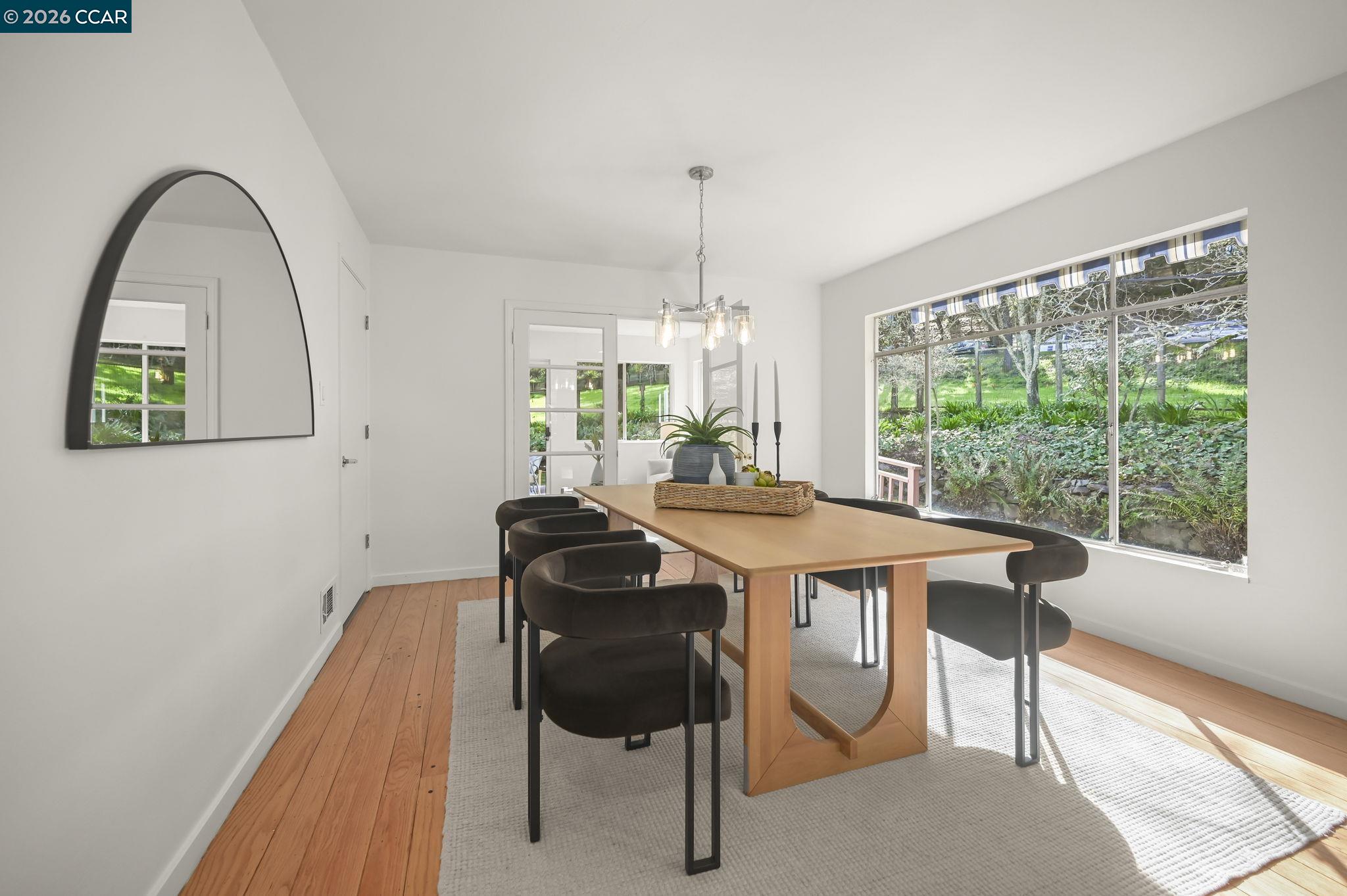 700 Miner Road Orinda, CA 94563 - Photo 7 of 37 a dining room with a table chairs and a floor to ceiling window