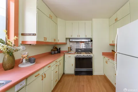 a kitchen with a sink a stove and refrigerator