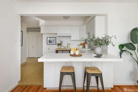 a dining table with chairs and potted plant on the table
