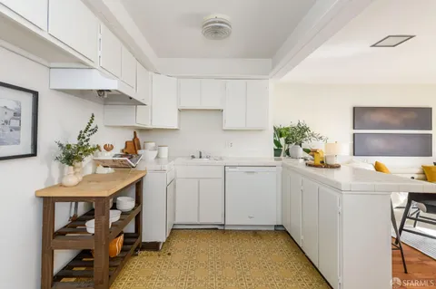 a kitchen with a sink a cabinets and window