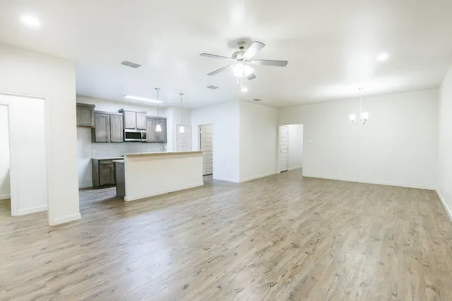 a view of a kitchen with a sink and a stove top oven