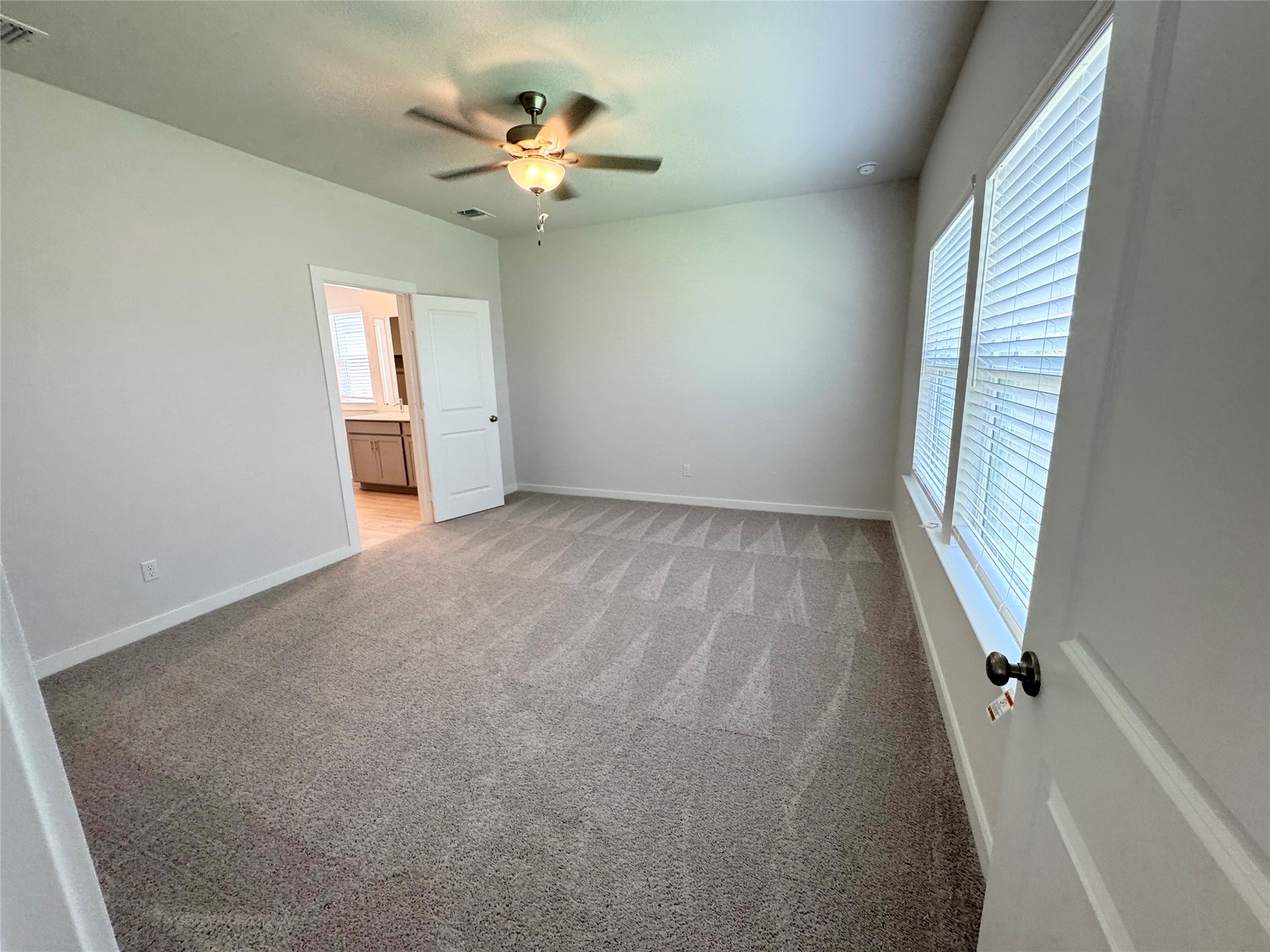 109 Corn Lane Hutto, TX 78634 - Photo 13 of 35 an empty room with windows and fan