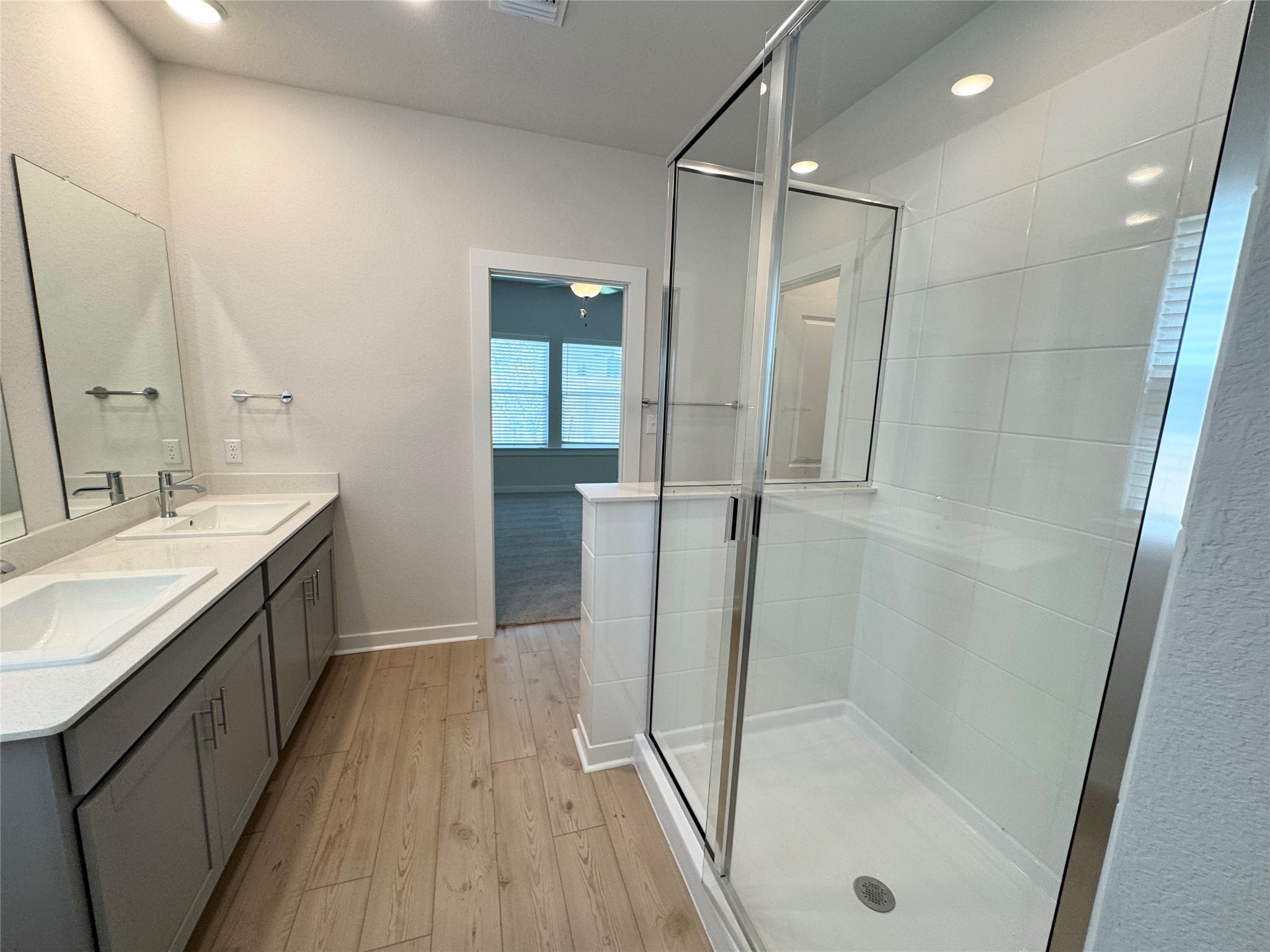 109 Corn Lane Hutto, TX 78634 - Photo 16 of 35 a bathroom with a double vanity sink a mirror and shower