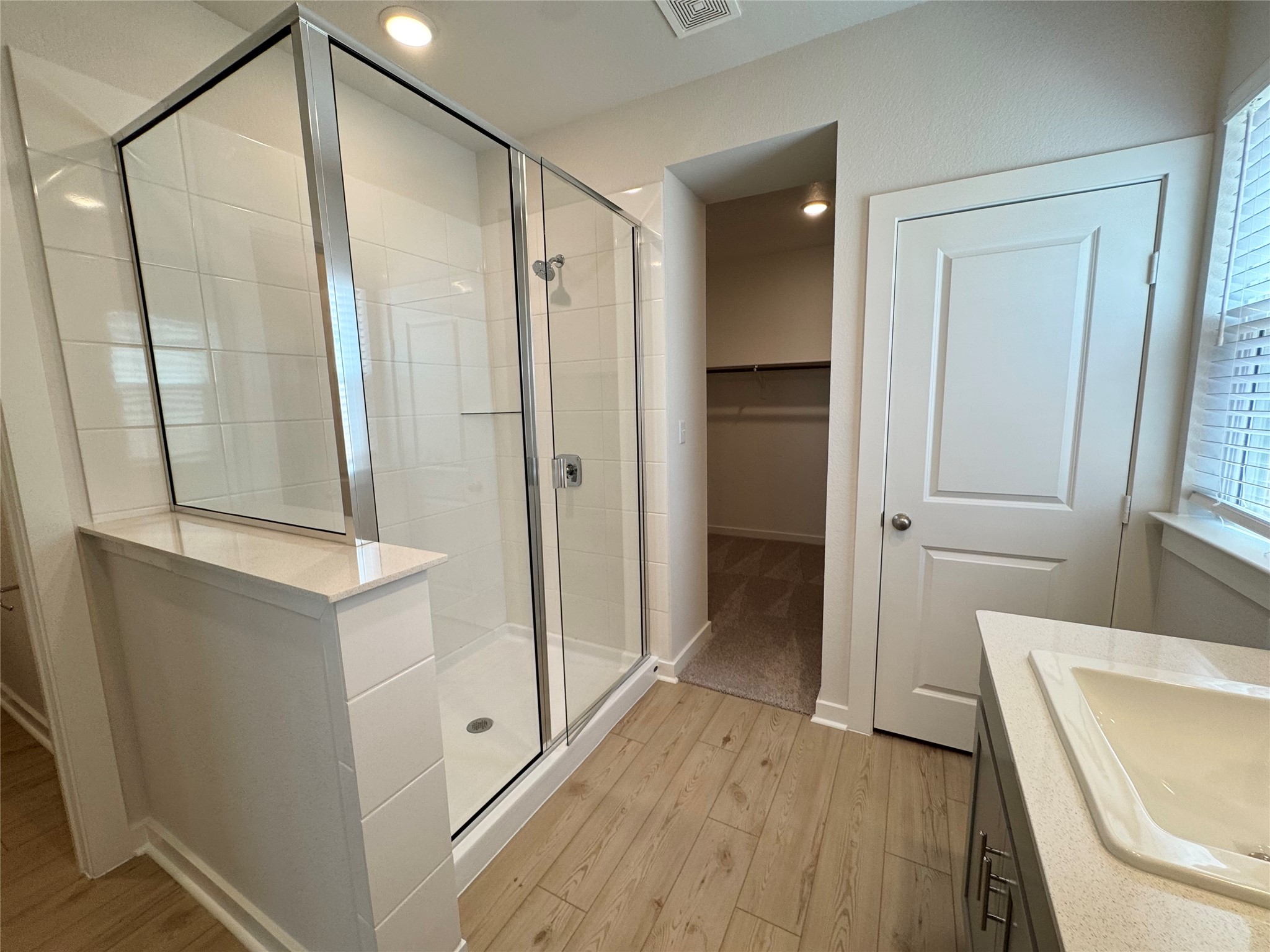 109 Corn Lane Hutto, TX 78634 - Photo 17 of 35 a bathroom with a glass door shower a sink and a mirror