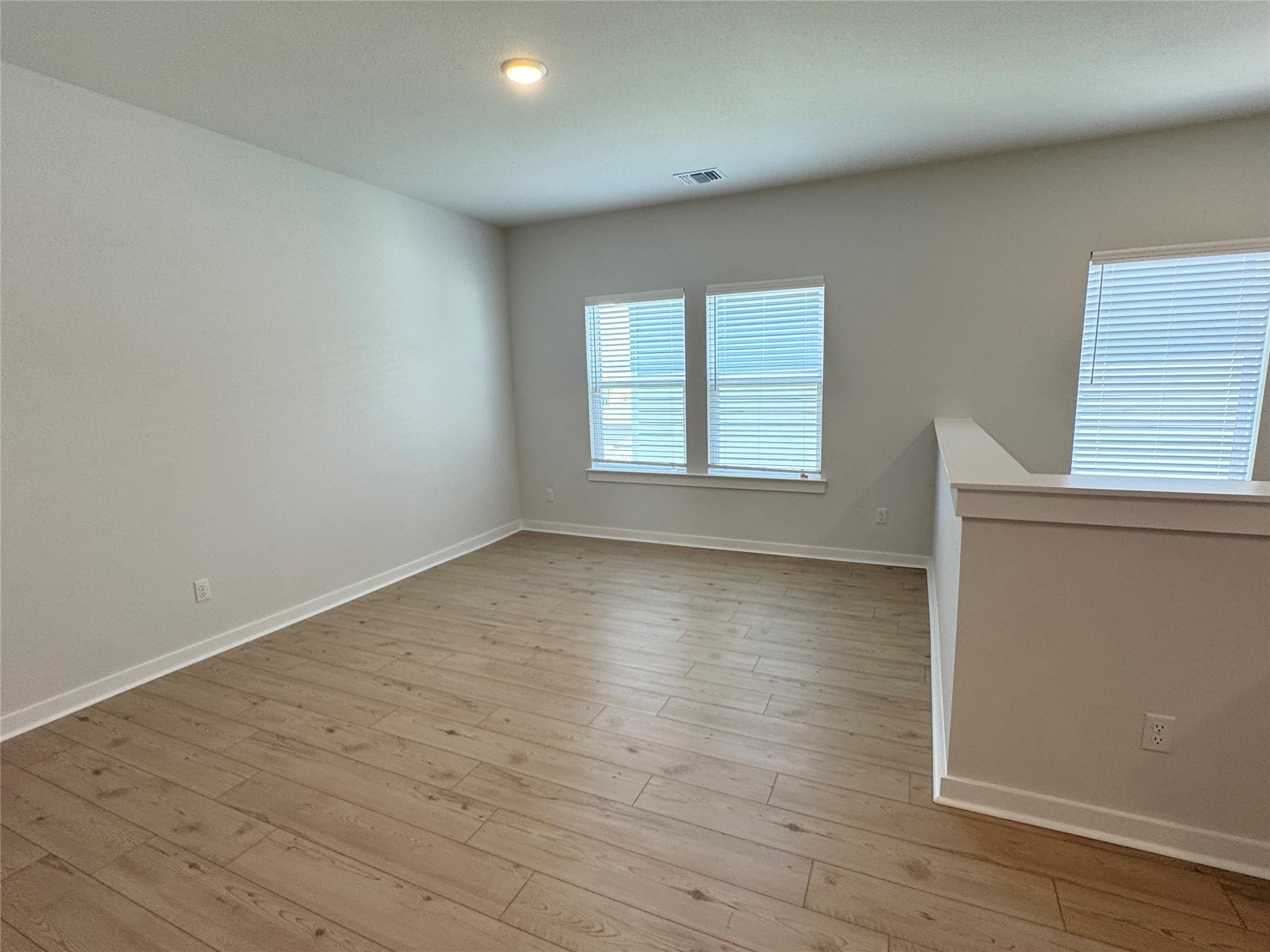 109 Corn Lane Hutto, TX 78634 - Photo 31 of 35 an empty room with wooden floor and windows