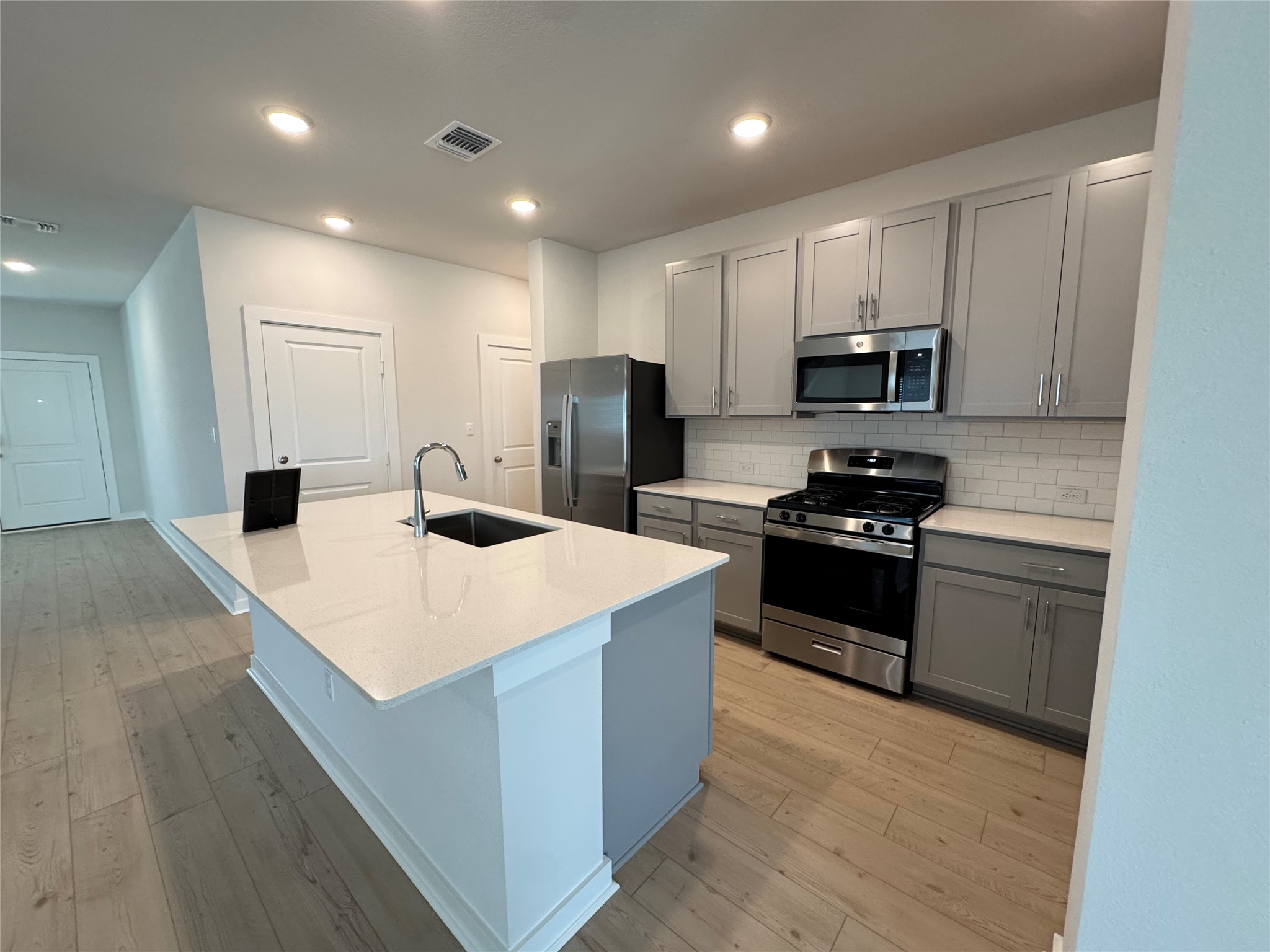 109 Corn Lane Hutto, TX 78634 - Photo 7 of 35 a kitchen with kitchen island sink stove and refrigerator
