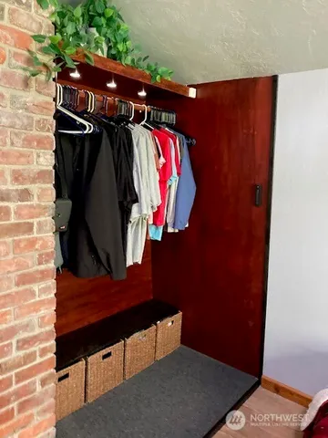a view of walk in closet with clothes