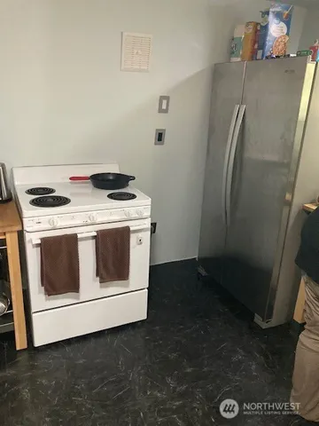 a stove top oven sitting inside of a kitchen