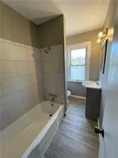 a bathroom with a bathtub and a sink