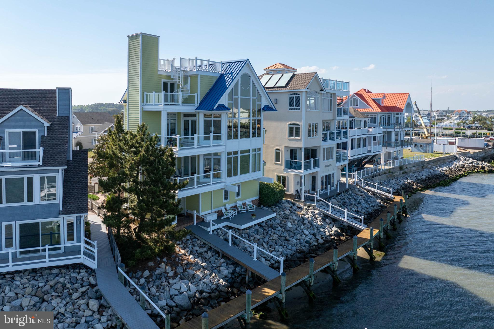 12959 Harbor Road Ocean City, MD 21842 - Photo 4 of 85 a front view of a residential apartment building with a yard
