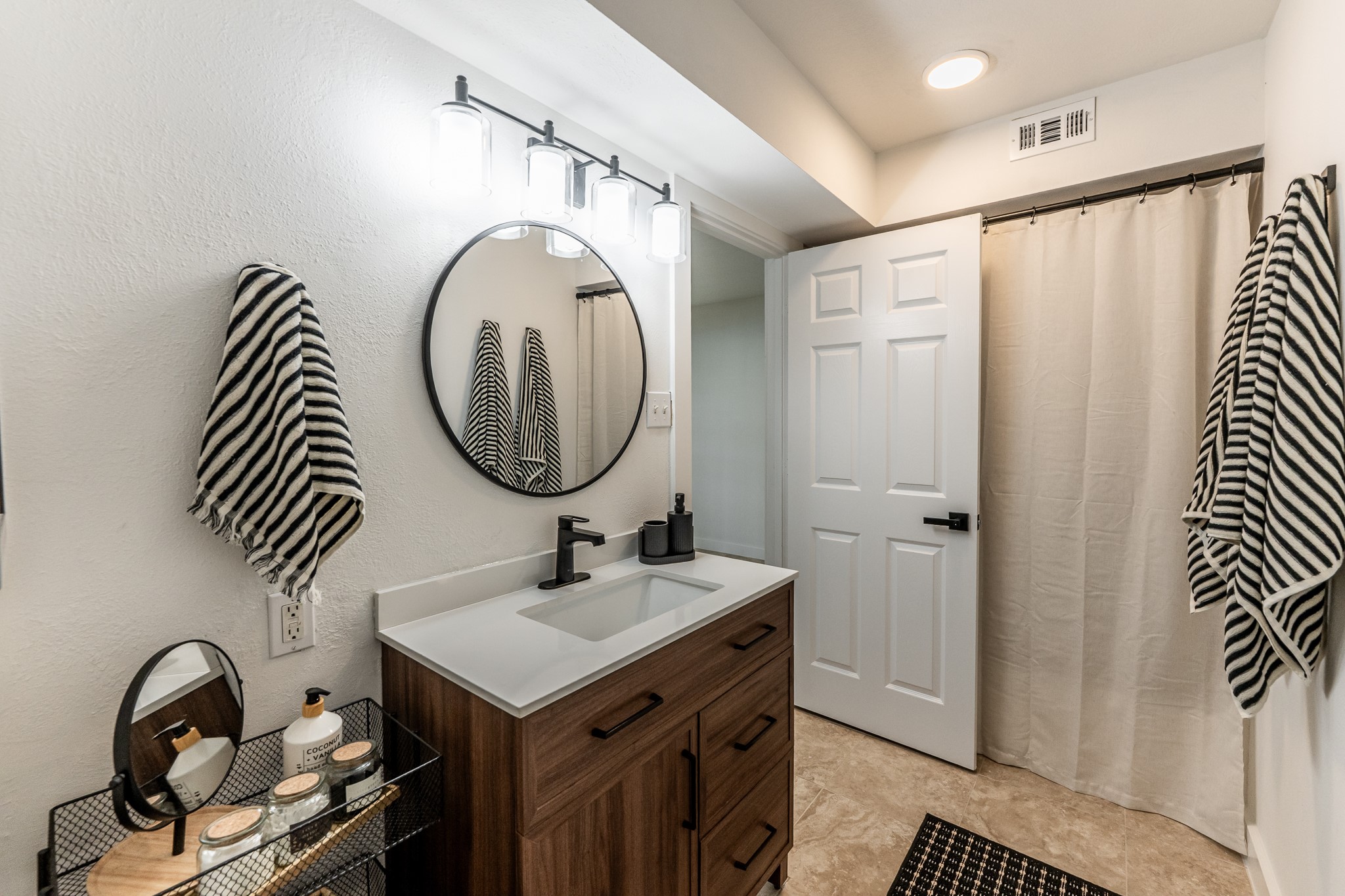 14 Lakeview Manor Huntsville, TX 77340 - Photo 36 of 48 a bathroom with a sink a mirror and a shower