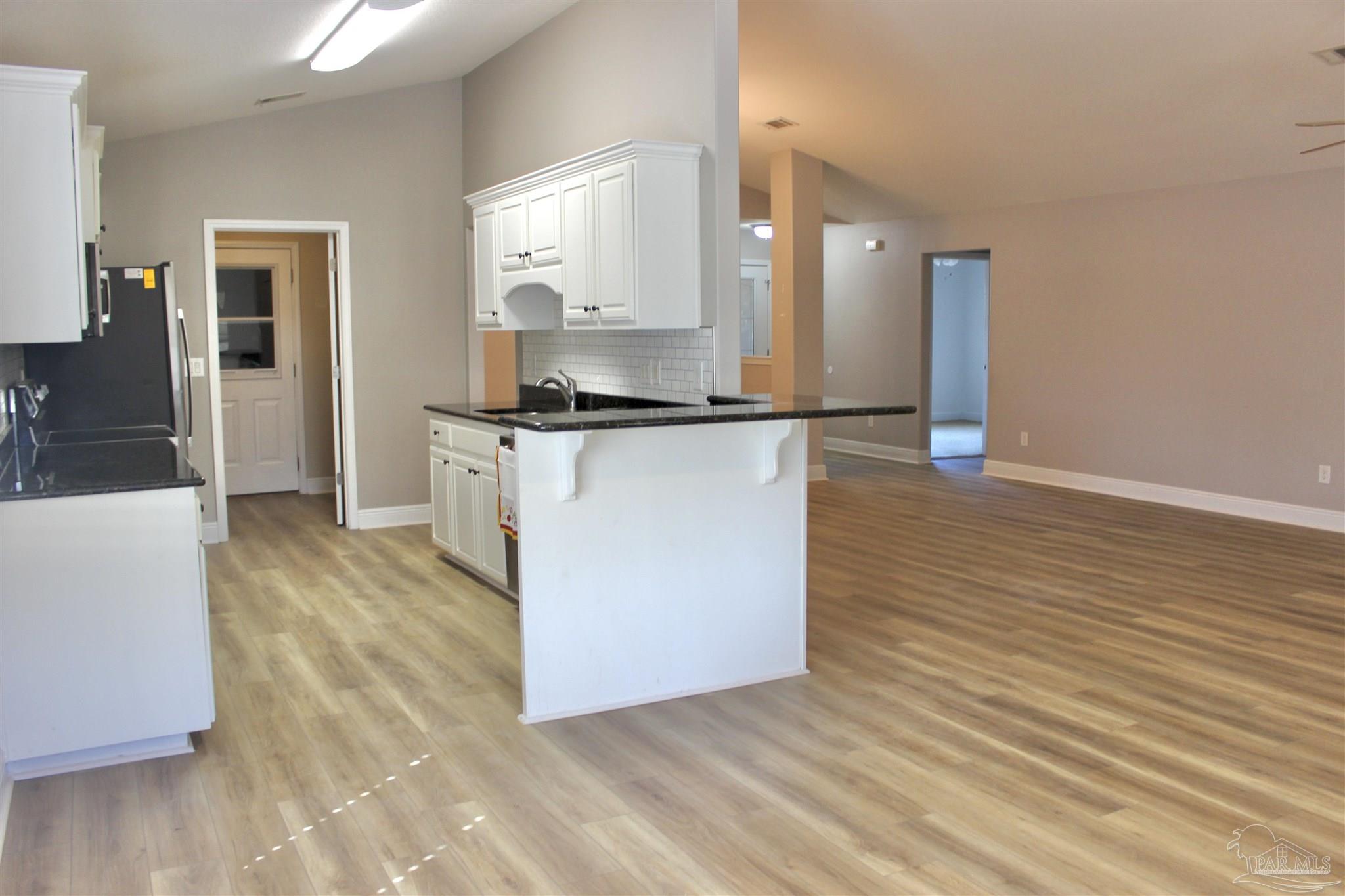6364 Parakeet Trail Pensacola, FL 32503 - Photo 13 of 72 a kitchen with stainless steel appliances granite countertop a stove a sink and a refrigerator
