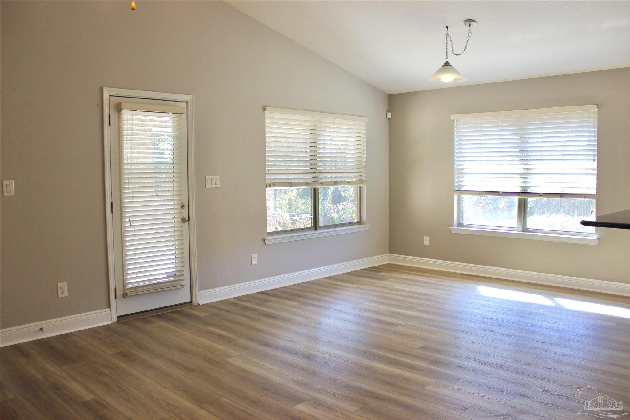 6364 Parakeet Trail Pensacola, FL 32503 - Photo 15 of 72 an empty room with wooden floor and windows