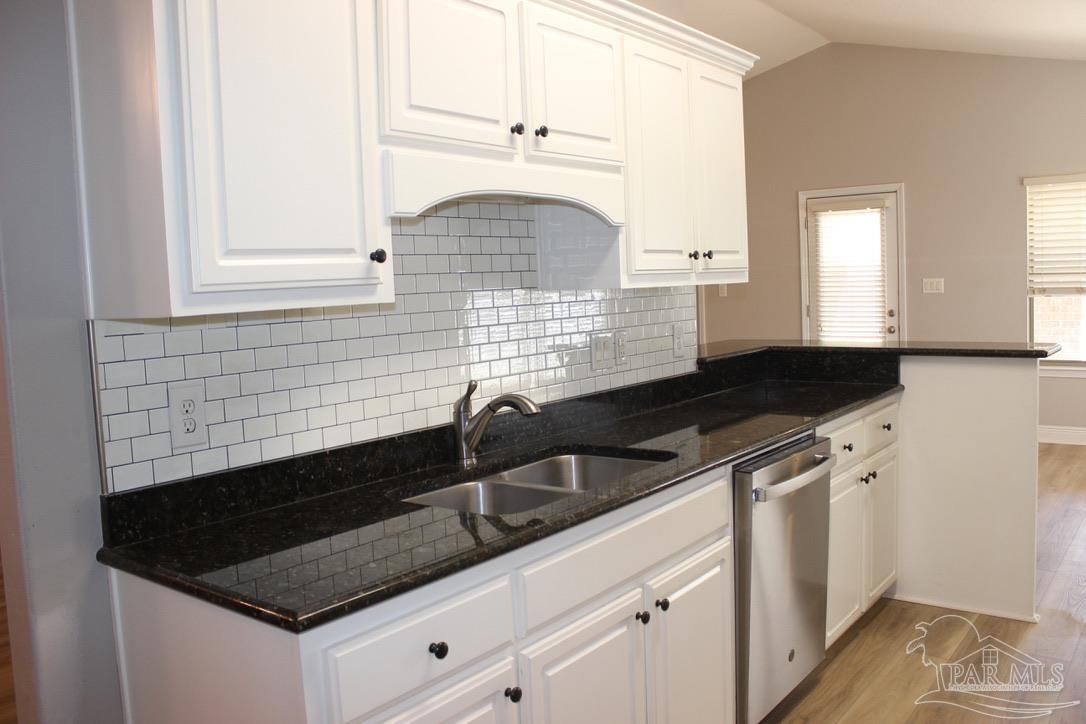 6364 Parakeet Trail Pensacola, FL 32503 - Photo 21 of 72 a kitchen with granite countertop white cabinets and a sink