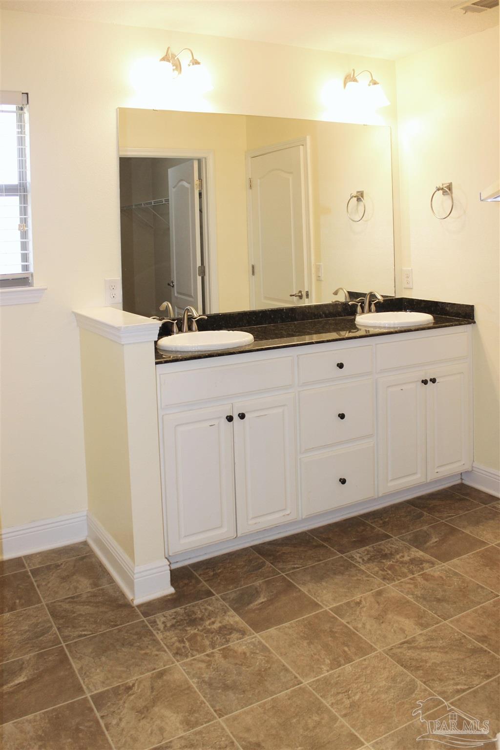 6364 Parakeet Trail Pensacola, FL 32503 - Photo 36 of 72 a bathroom with a sink and a mirror