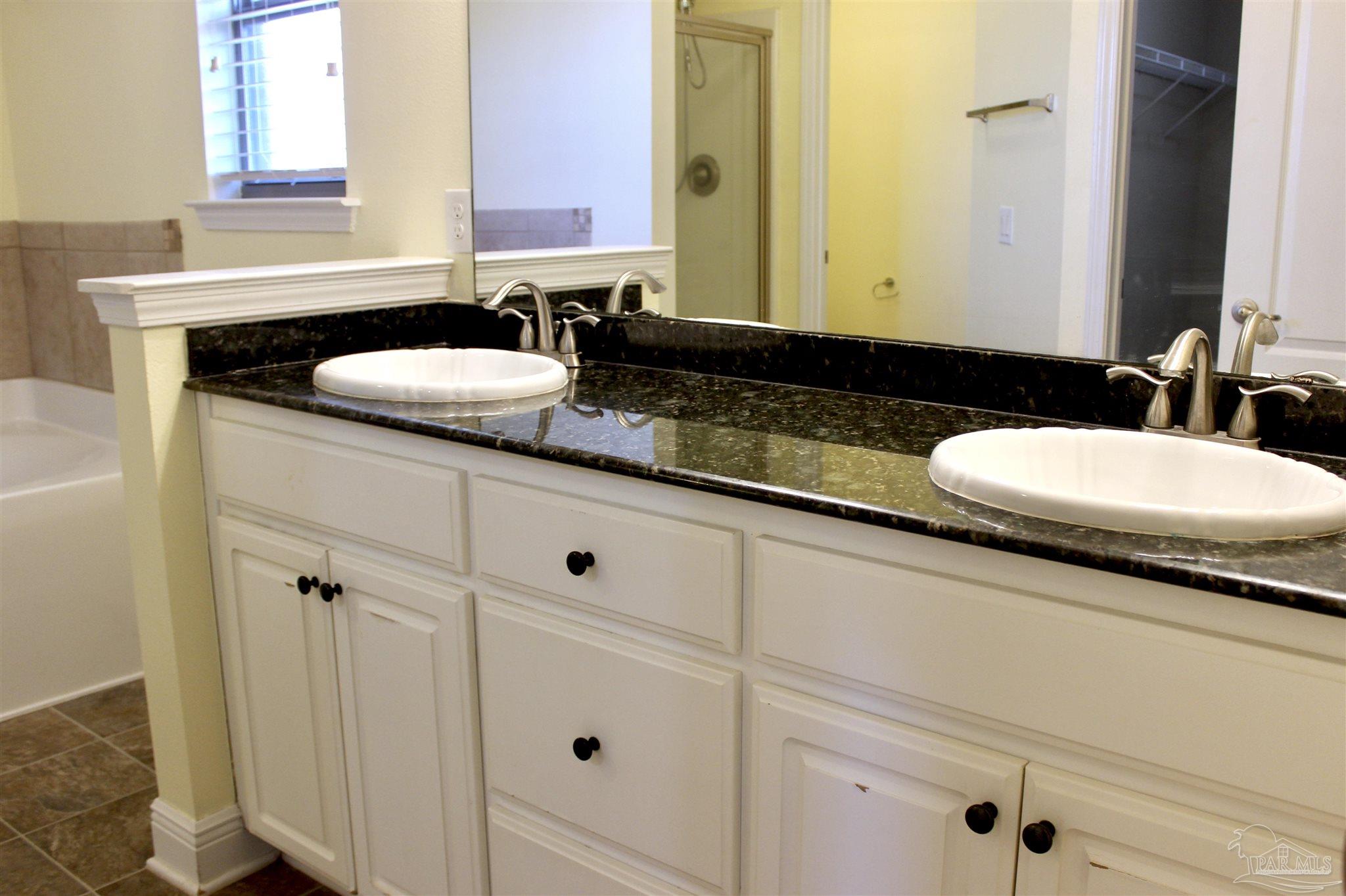 6364 Parakeet Trail Pensacola, FL 32503 - Photo 37 of 72 a bathroom with a sink and a mirror