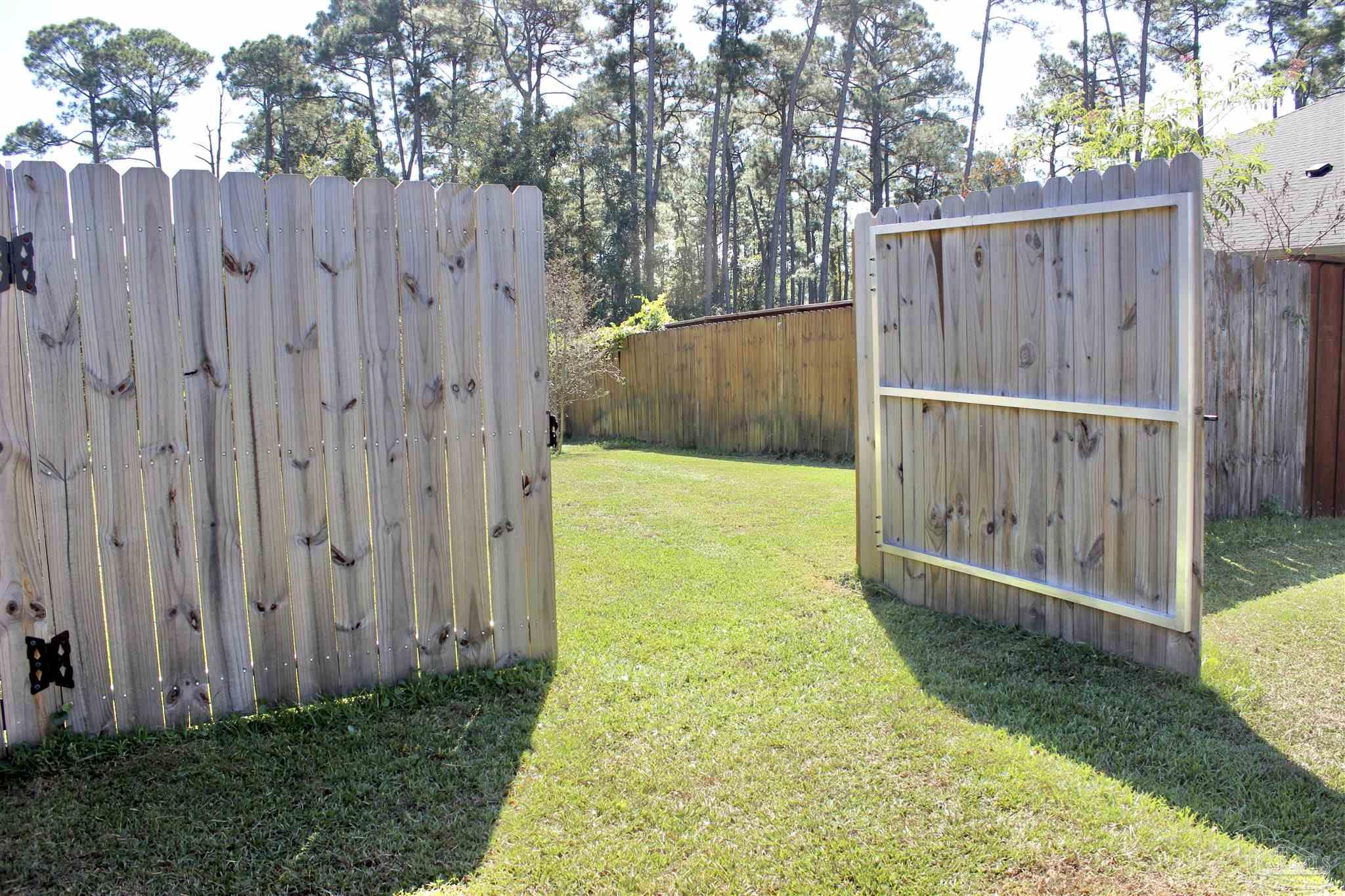 6364 Parakeet Trail Pensacola, FL 32503 - Photo 51 of 72 a view of a backyard with wooden fence