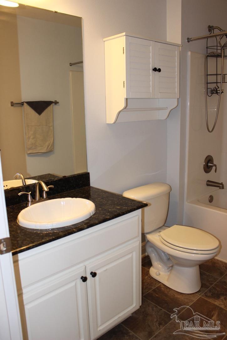 6364 Parakeet Trail Pensacola, FL 32503 - Photo 58 of 72 a bathroom with a granite countertop sink mirror vanity and toilet