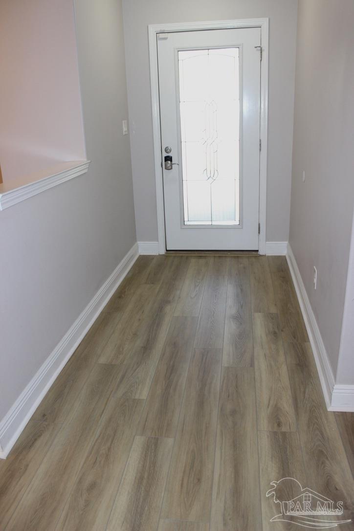 6364 Parakeet Trail Pensacola, FL 32503 - Photo 10 of 72 a view of an empty room with wooden floor and a window