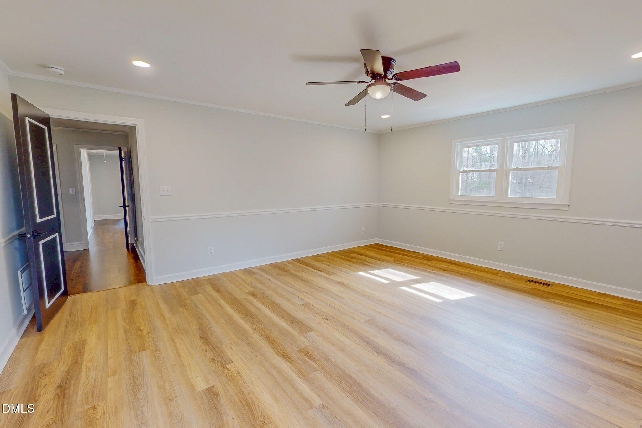 844 Holeman Ashley Road Timberlake, NC 27583 - Photo 21 of 58 a view of a room with wooden floor and a ceiling fan