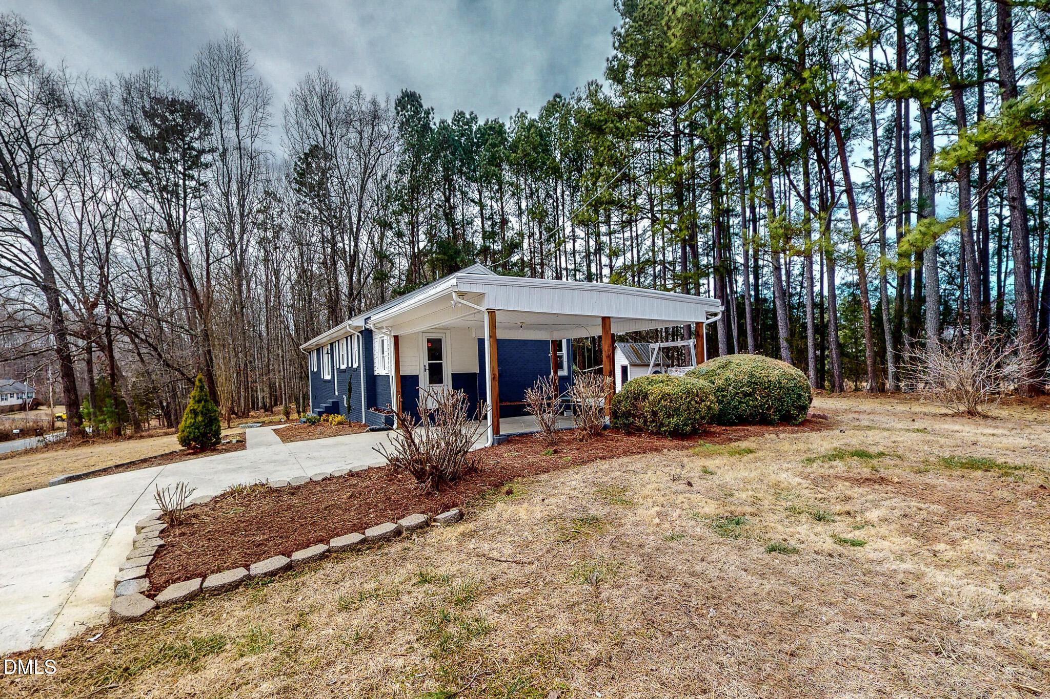 844 Holeman Ashley Road Timberlake, NC 27583 - Photo 22 of 58 a front view of a house with a yard outdoor seating and covered with trees